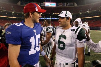 EAST RUTHERFORD, NJ - AUGUST 29:  Eli Manning #10 of the New York Giants talks with Mark Sanchez #6 of the New York Jets after their game on August 29, 2009 at Giants Stadium in East Rutherford, New Jersey.  (Photo by Jim McIsaac/Getty Images)