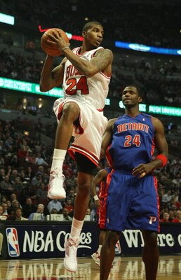 CHICAGO - MARCH 24: Tyrus Thomas #24 of the Chicago Bulls grabs a rebound in front of Antonio McDyees #24 of the Detroit Pistons on March 24, 2009 at the United Center in Chicago, Illinois. The Bulls defeated the Pistons 99-91. NOTE TO USER: User expressl