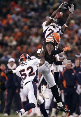 CLEVELAND - OCTOBER 22:  Champ Bailey #24 of the Denver Broncos can't make a catch for an interception in front of teammate Ian Gold #52 and Braylon Edwards #17 of the Cleveland Browns during the third quarter at Cleveland Browns Stadium on October 22, 20