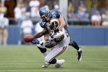 SEATTLE, WA - SEPTEMBER 13:  Randy McMichael #84 of the St. Louis Rams is tackled by Will Herring #54 of the Seattle Seahawks on September 13, 2009 at Qwest Field in Seattle, Washington. The Seahawks defeated the Rams 28-0. (Photo by Otto Greule Jr/Getty 