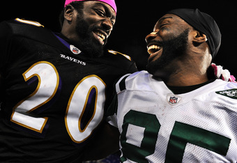 Ray Lewis and Edgerton Hartwell of the Baltimore Ravens tackle