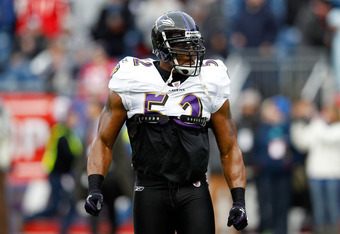 Ray Lewis and Edgerton Hartwell of the Baltimore Ravens tackle