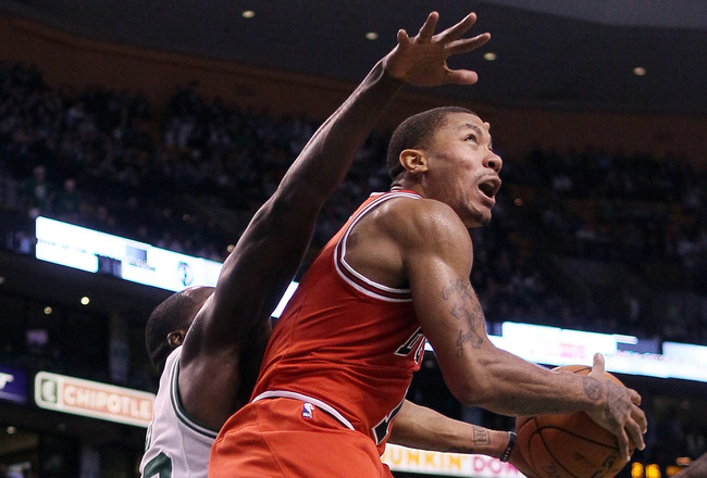 BOSTON, MA - JANUARY 13:  Derrick Rose #1 of the Chicago Bulls heads for the basket as Brandon Bass #30 of the Boston Celtics defends on January 13, 2012 at TD Garden in Boston, Massachusetts. The Chicago Bulls defeated the Boston Celtics 79-88. NOTE TO USER: User expressly acknowledges and agrees that, by downloading and or using this photograph, User is consenting to the terms and conditions of the Getty Images License Agreement.  (Photo by Elsa/Getty Images)