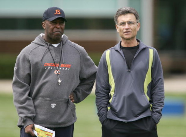 LAKE FOREST, IL - MAY 4: The head coach Lovie Smith (L) and general manager Jerry Angelo of the Chicago Bears look over players during a rookie mini-camp practice at Halas Hall May 4, 2007 in Lake Forest, Illinois. (Photo by Jonathan Daniel/Getty Images)