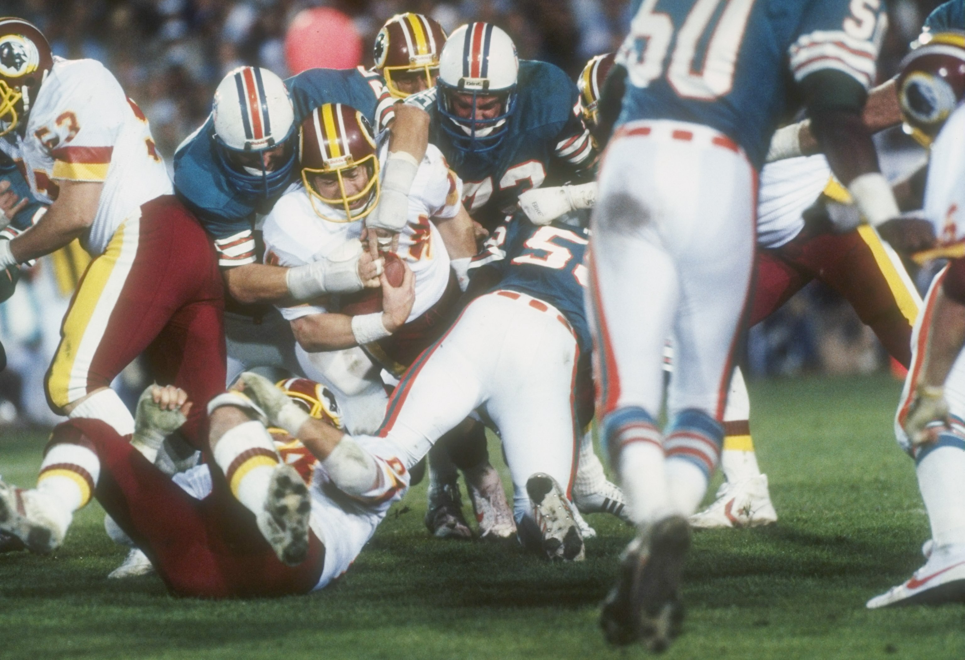 30 Jan 1983:  Running back John Riggins (center with ball) of the Washington Redskins is stopped by the Miami defensive line during the Super Bowl XVII at the Rose Bowl in Pasadena, California.  The Redskins won the game, 27-17. Mandatory Credit: Allsport