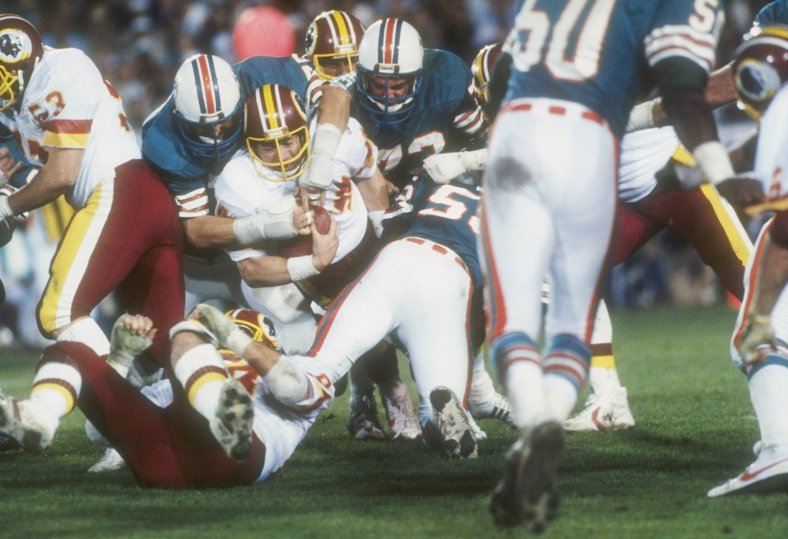 30 Jan 1983:  Running back John Riggins (center with ball) of the Washington Redskins is stopped by the Miami defensive line during the Super Bowl XVII at the Rose Bowl in Pasadena, California.  The Redskins won the game, 27-17. Mandatory Credit: Allsport