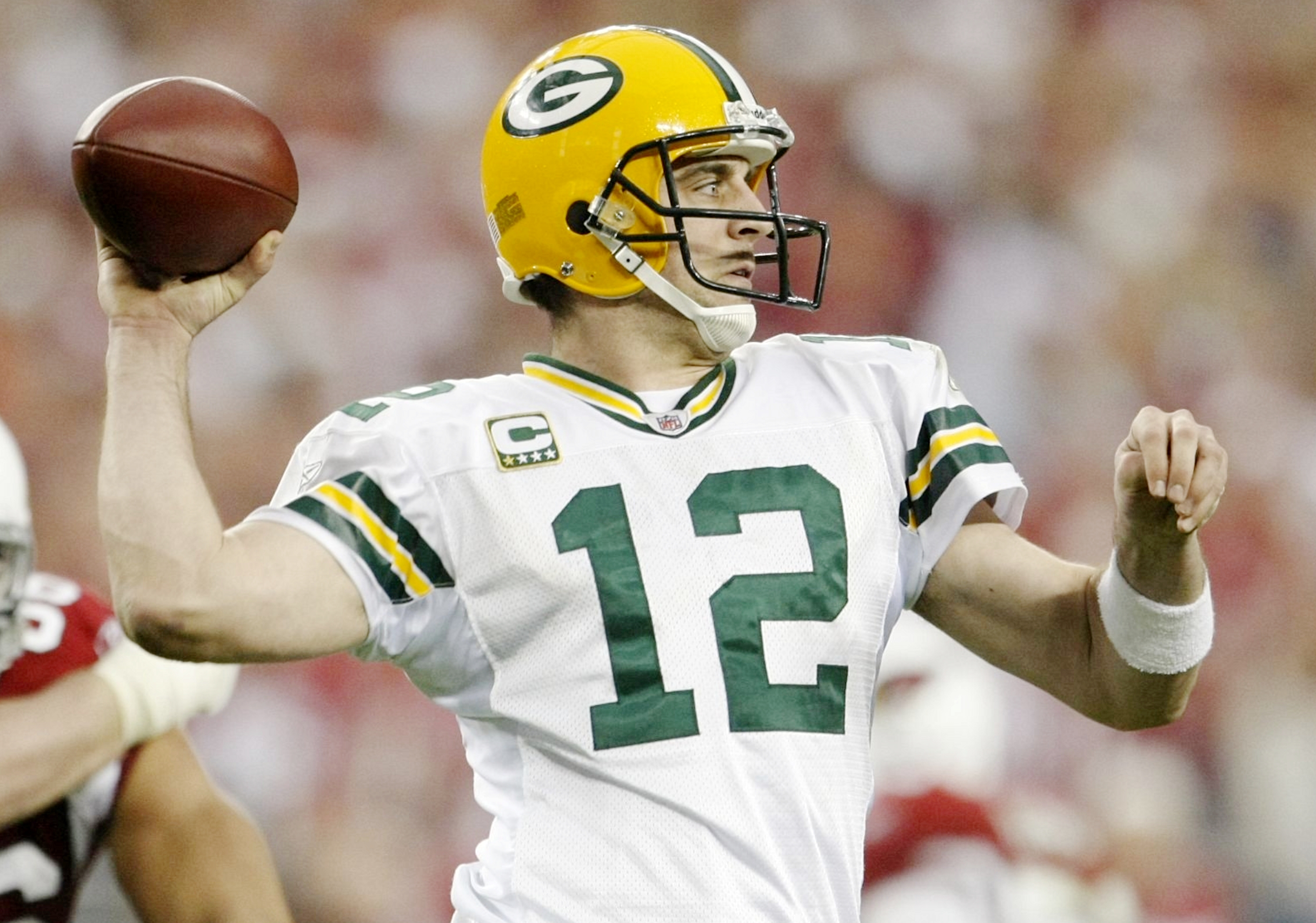 GLENDALE, AZ - JANUARY 10:  Quarterback Aaron Rodgers #12 of the Green Bay Packers throws a pass against the Arizona Cardinals during the 2010 NFC wild-card playoff game at University of Phoenix Stadium on January 10, 2010 in Glendale, Arizona.   (Photo b