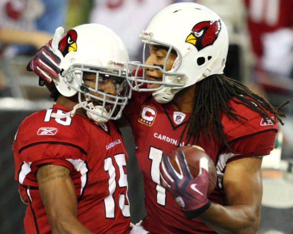 GLENDALE, AZ - JANUARY 10:  Steve Breaston #15 of the Arizona Cardinals celebrates his touchdown with teammate Larry Fitzgerald #11 during the fourth quarter of the 2010 NFC wild-card playoff game against the Green Bay Packers at University of Phoenix Sta
