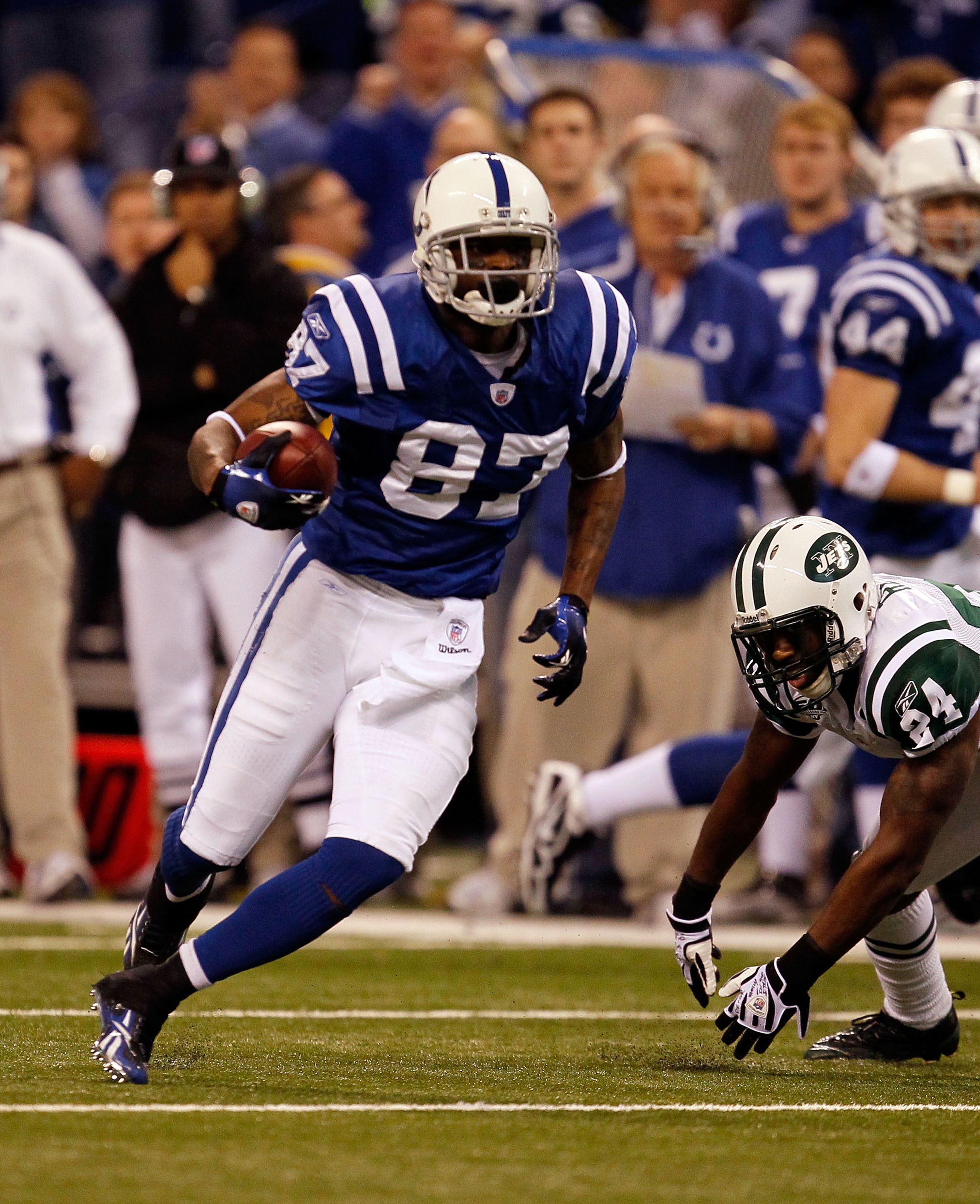 INDIANAPOLIS - JANUARY 24:  Wide receiver Reggie Wayne #87 of the Indianapolis Colts runs the ball while playing against the New York Jets during the AFC Championship Game at Lucas Oil Stadium on January 24, 2010 in Indianapolis, Indiana. The Colts defeat