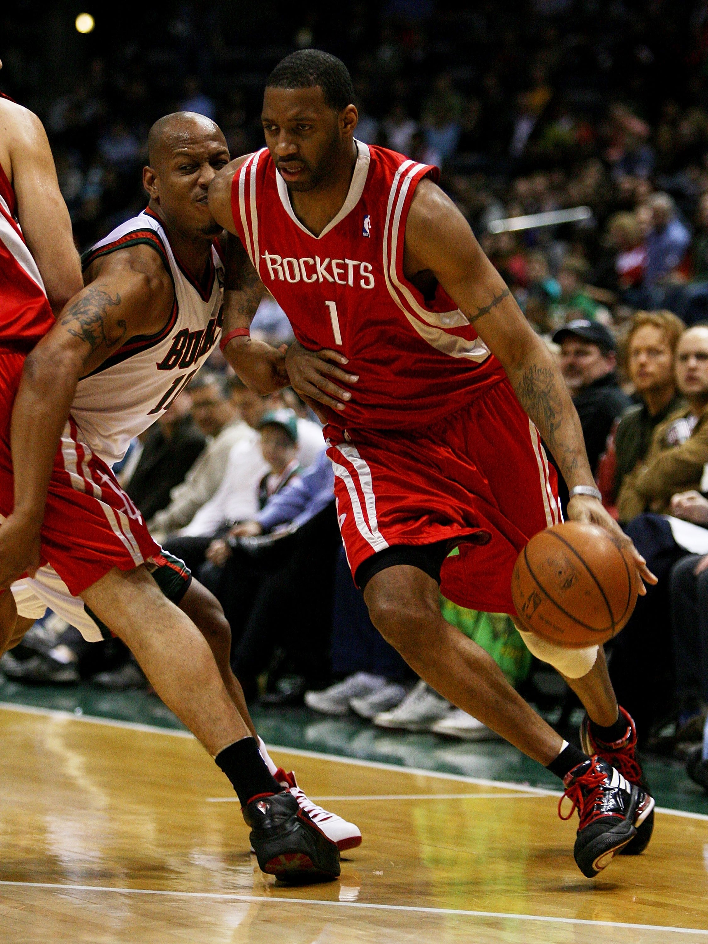 MILWAUKEE - FEBRUARY 09: Tracy McGrady #1 of the Houston Rockets collides with Keith Bogans #10 of the Milwaukee Bucks on a screen set by Yao Ming #11 on February 9, 2009 at the Bradley Center in Milwaukee, Wisconsin. The Bucks defeated the Rockets 124-11