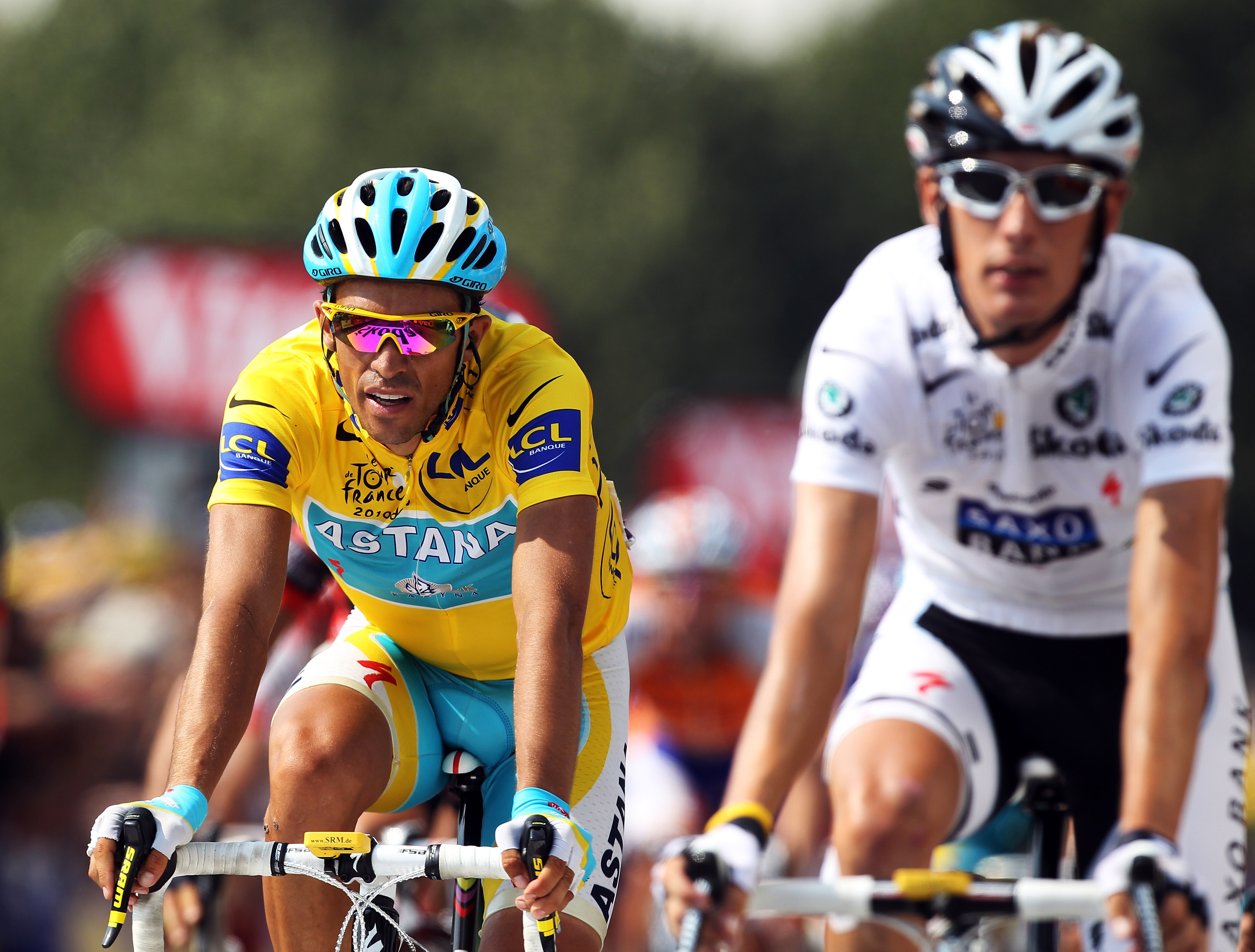 PAU, FRANCE - JULY 20: Race leader Alberto Contador (l) of Spain and the Astana team rides over the finish line alongside second placed Andy Schleck of Luxembourg and Team Saxo Bank on stage sixteen of the 2010 Tour de France from Bagneres-de-Luchon to P