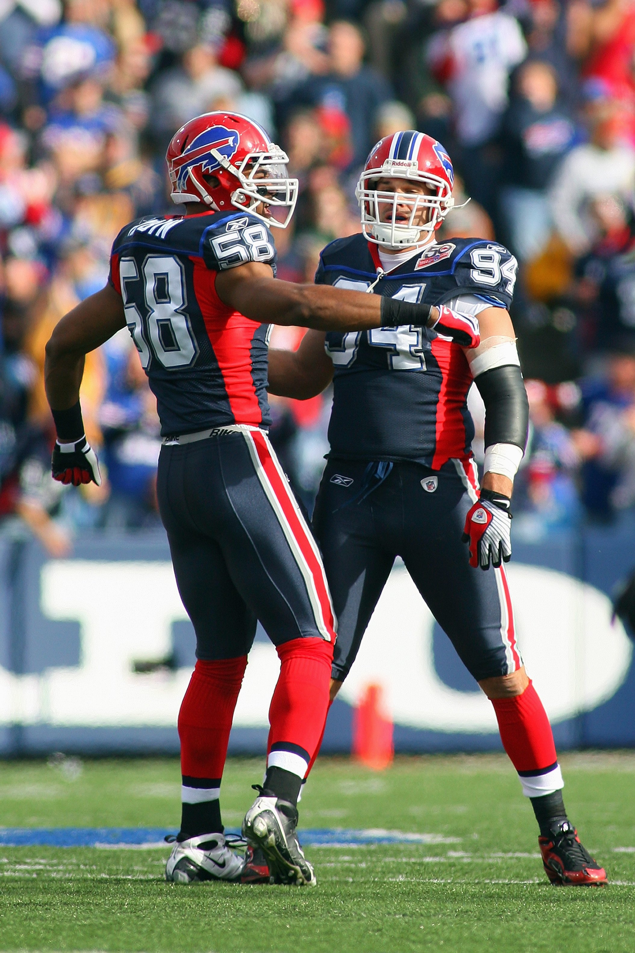 14 September 2009. Buffalo Defensive Ends Aaron Schobel (94) and Aaron  Maybin with a first quarter sack of Patriot Quarterback Tom Brady (12). The New  England Patriots defeated the Buffalo Bills 25