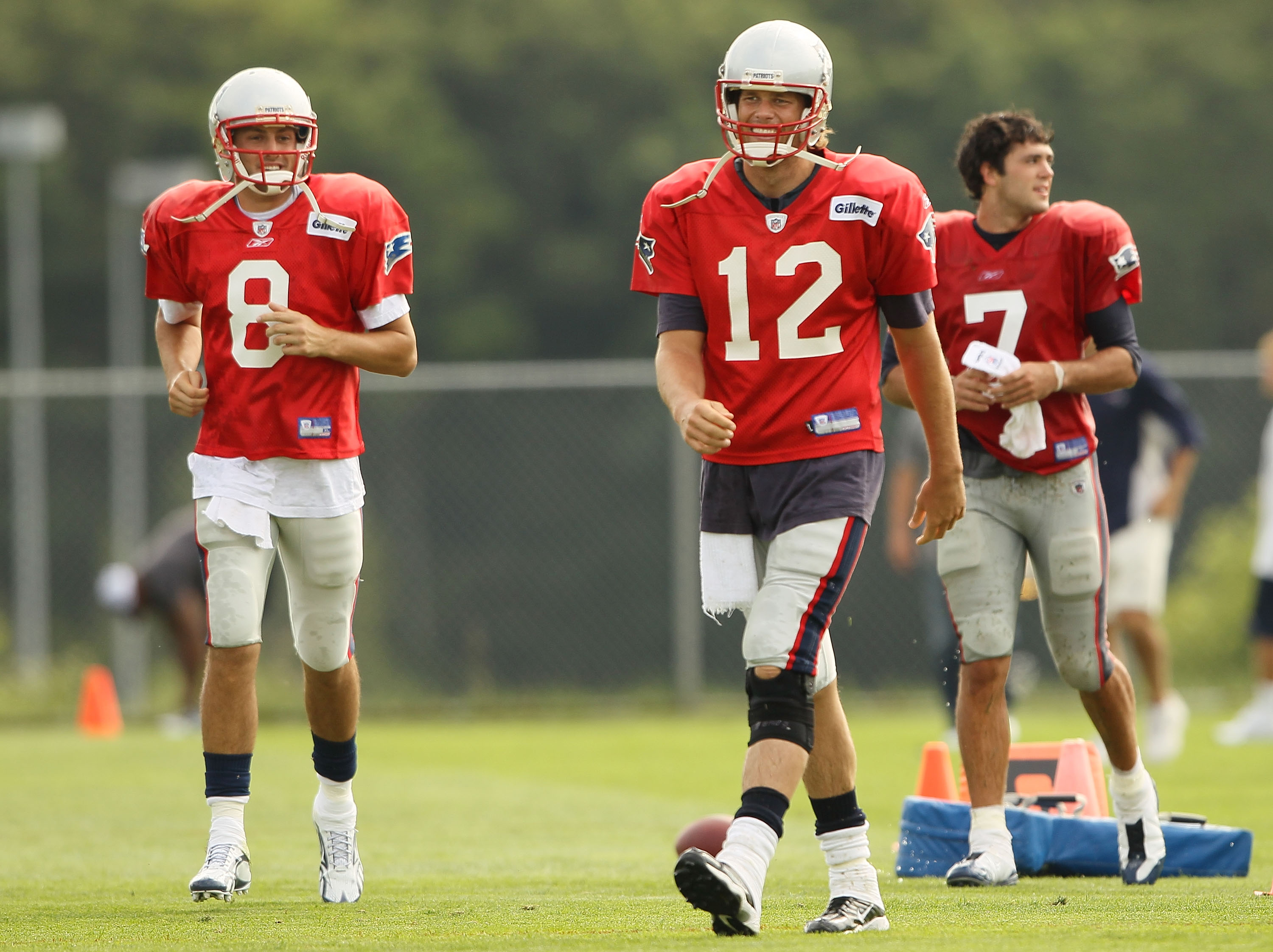 FOXBORO, MA - AUGUST 02:  Quarterbacks Brian Hoyer #8,Tom Brady #12 and Zac Robinson #7 of the New England Patriots head to their next drill during training camp on August 2, 2010 at Gillette Stadium in Foxboro, Massachusetts.  (Photo by Elsa/Getty Images
