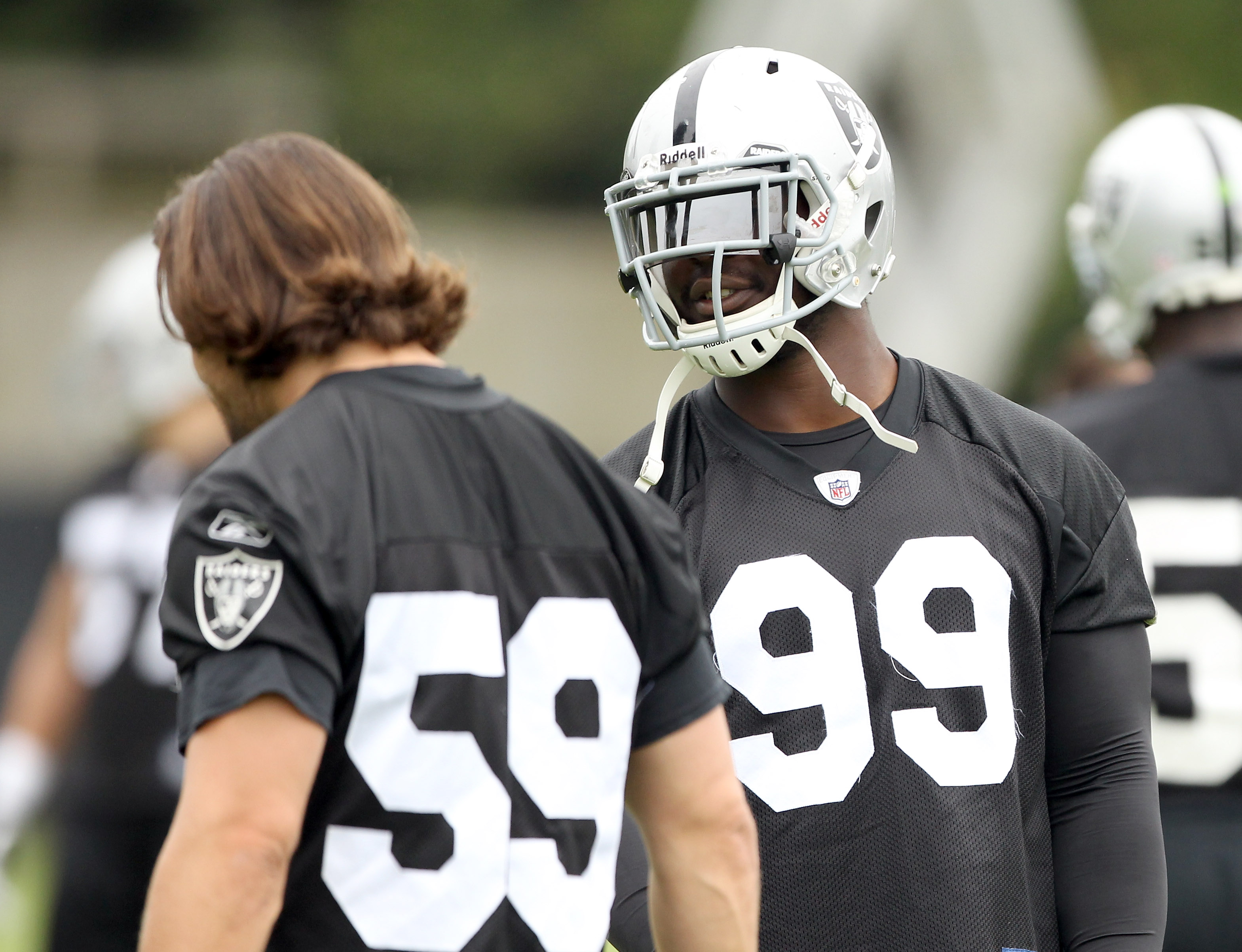 Raiders defensive end Clelin Ferrell (99) warms up on the field