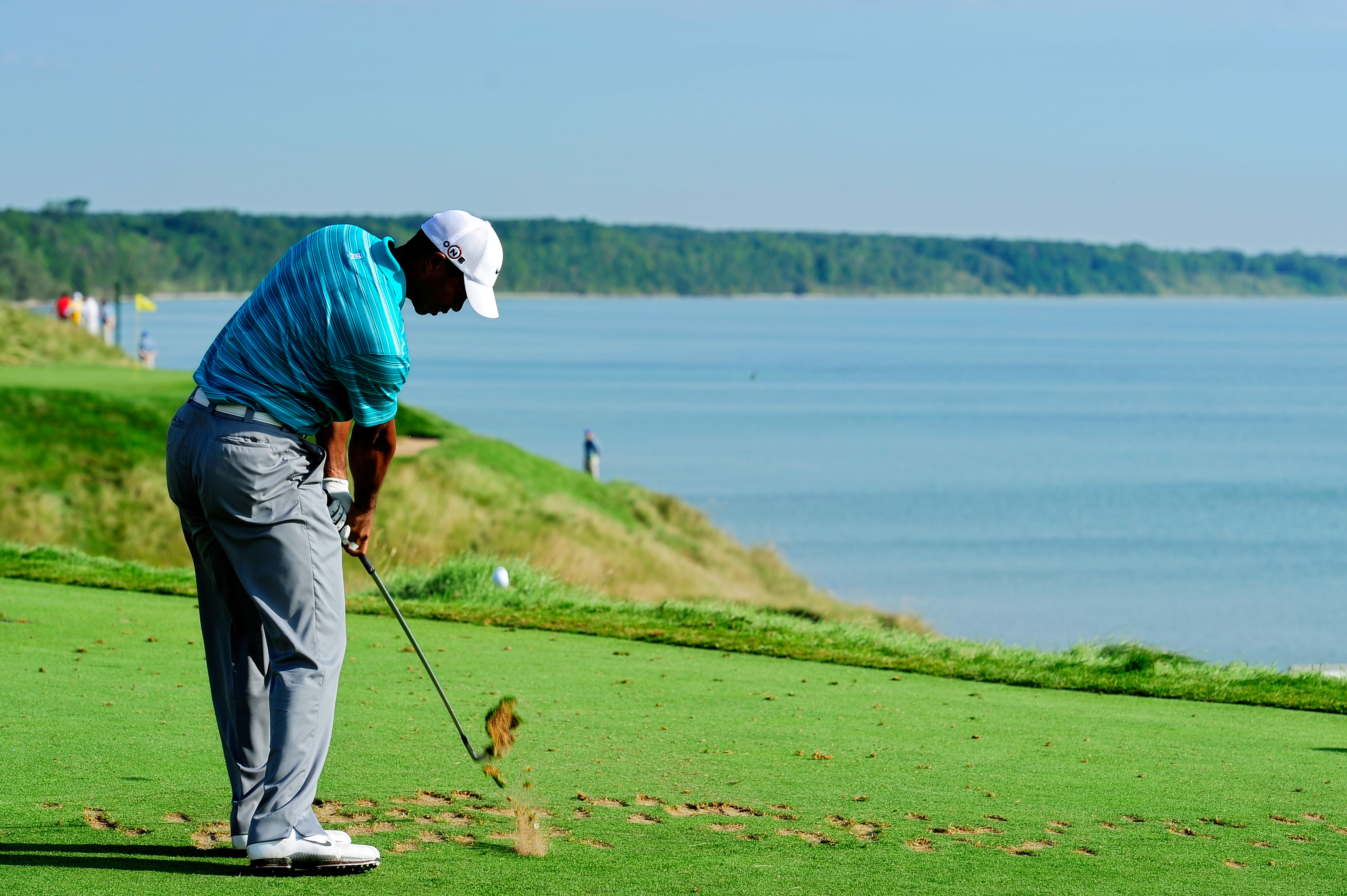 KOHLER, WI - AUGUST 14:  Tiger Woods hits his tee shot on the 12th hole during the continuation of the second round of the 92nd PGA Championship on the Straits Course at Whistling Straits on August 14, 2010 in Kohler, Wisconsin.  (Photo by Stuart Franklin