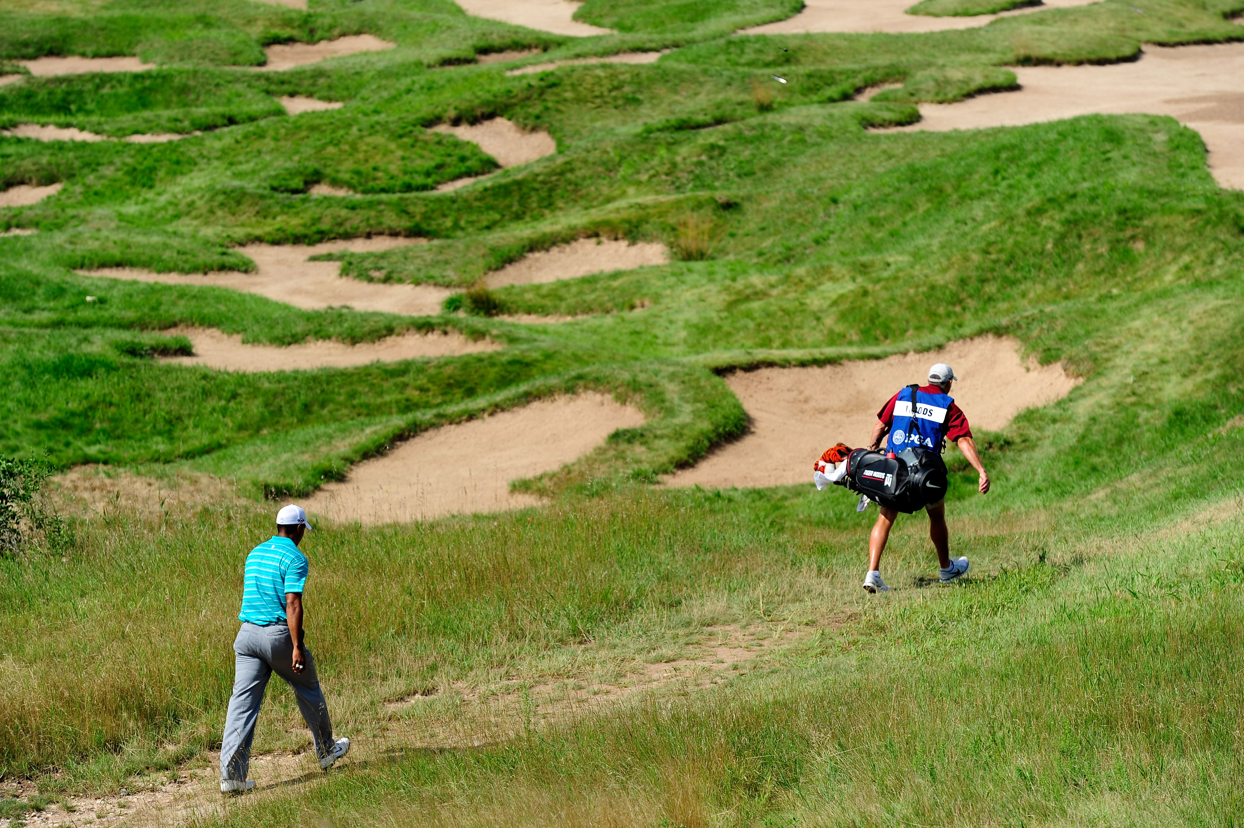 KOHLER, WI - AUGUST 14:  Tiger Woods walks with his caddie Steve Williams on the 18th hole during the continuation of the second round of the 92nd PGA Championship on the Straits Course at Whistling Straits on August 14, 2010 in Kohler, Wisconsin.  (Photo