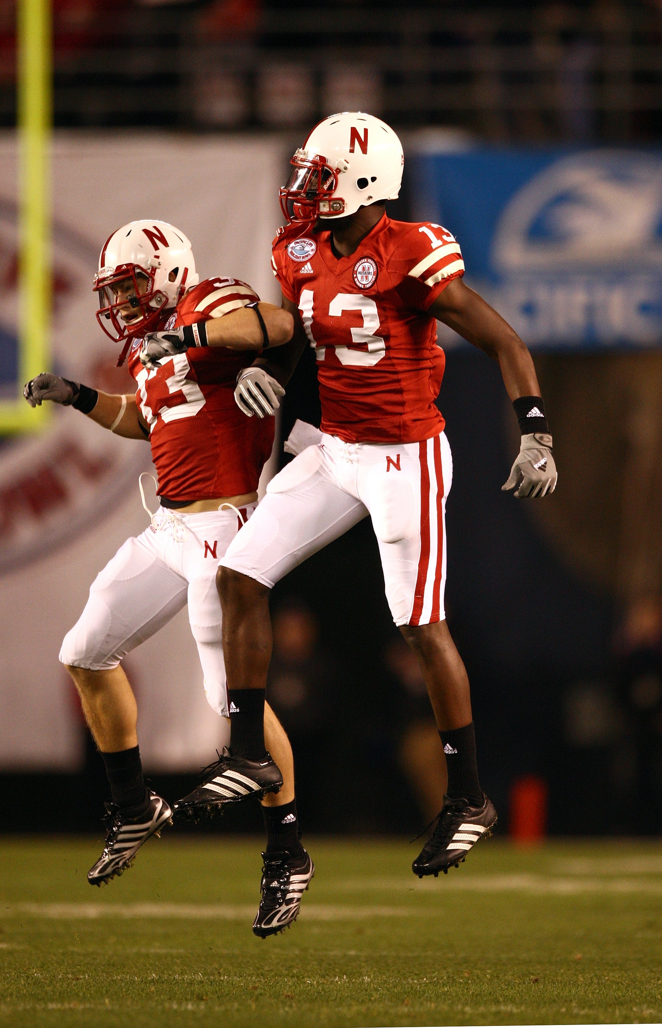 SAN DIEGO - DECEMBER 30: P.J. Smith #13 and Matt O'Hanlon #33 of the University of Nebraska Cornhuskers celebrate after a defensive play during the Pacific Life Holiday Bowl against University of Arizona Wildcats on December 30, 2009 at Qualcomm Stadium