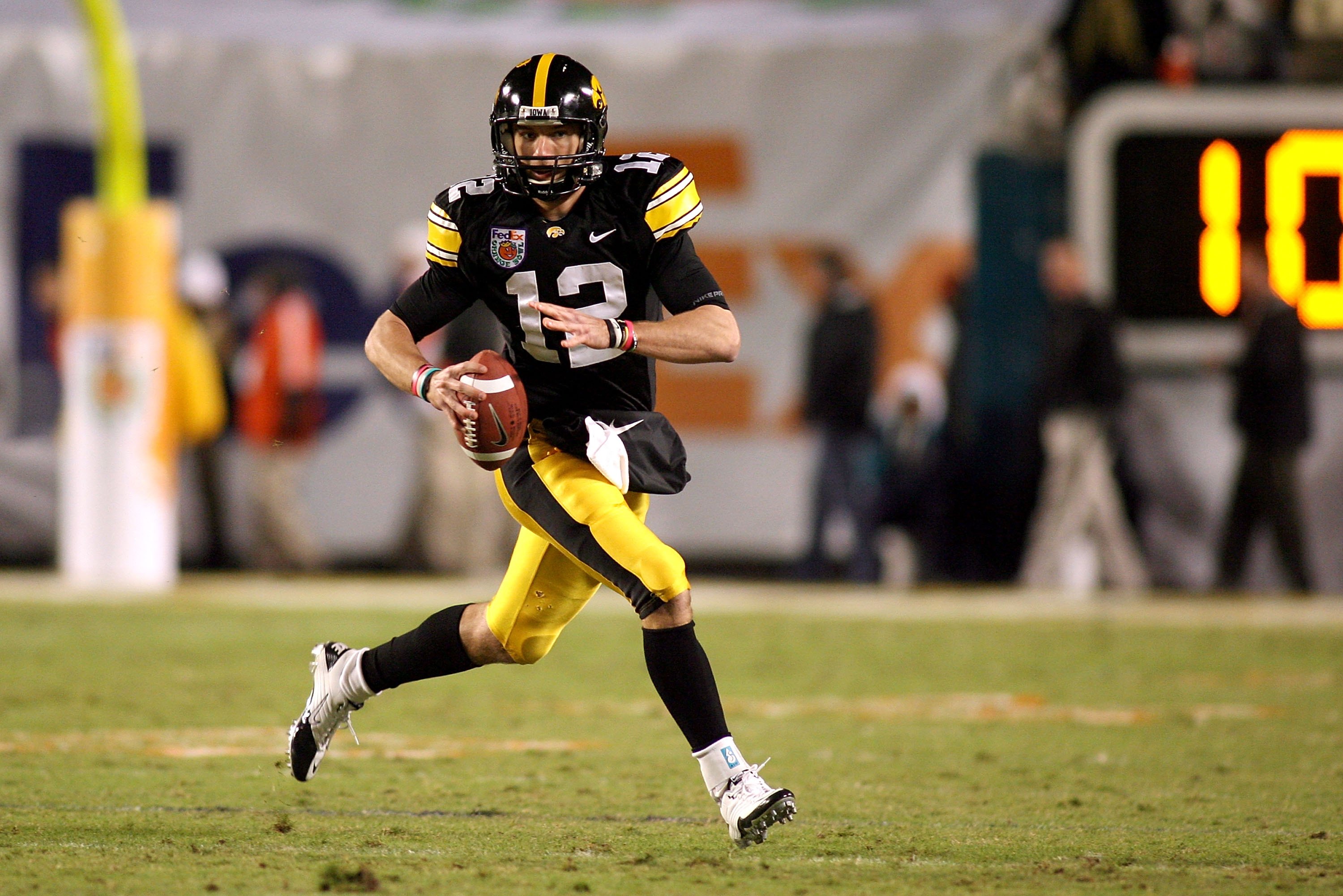 MIAMI GARDENS, FL - JANUARY 05: Quarterback Richy Stanzi #12 of the Iowa Hawkeyes rolls out of the pocket against the Georgia Tech Yellow Jackets during the FedEx Orange Bowl at Land Shark Stadium on January 5, 2010 in Miami Gardens, Florida. Iowa won 24