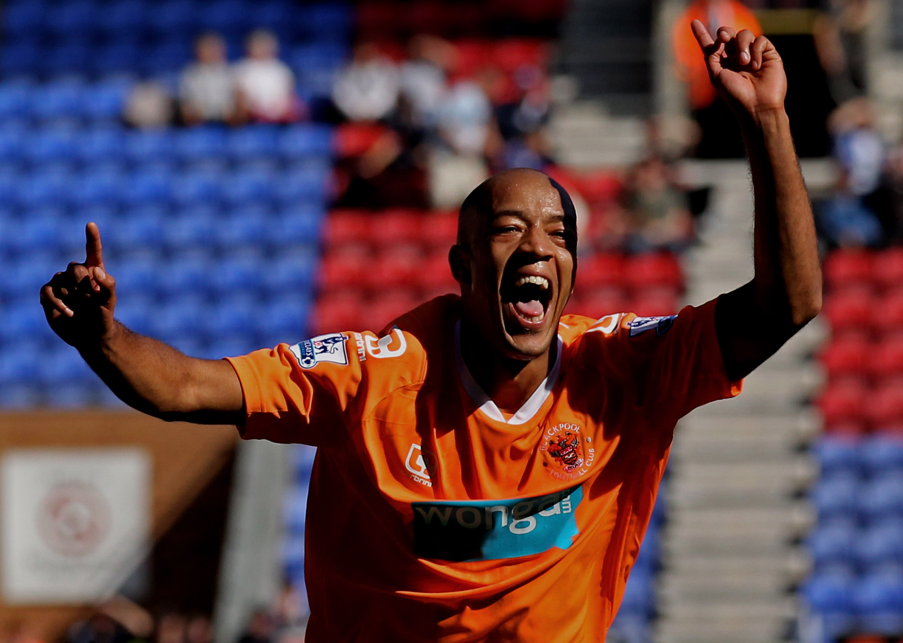 WIGAN, ENGLAND - AUGUST 14:  Alex Baptiste of Blackpool celebrates scoring his team's fourth goal during the Barclays Premier League match between Wigan Athletic and Blackpool at the DW Stadium on August 14, 2010 in Wigan, England.  (Photo by Alex Livesey