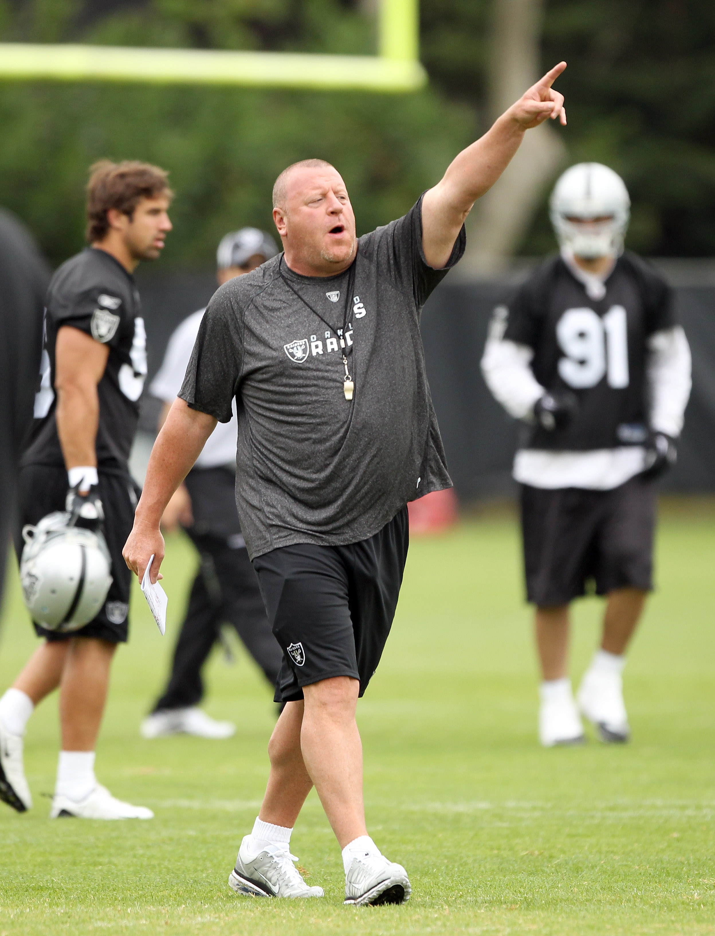 NAPA, CA - AUGUST 01:  Head coach Tom Cable of the Oakland Raiders shouts to his team during the Raiders training camp at their Napa Valley Training Complex on August 1, 2010 in Napa, California.  (Photo by Ezra Shaw/Getty Images)