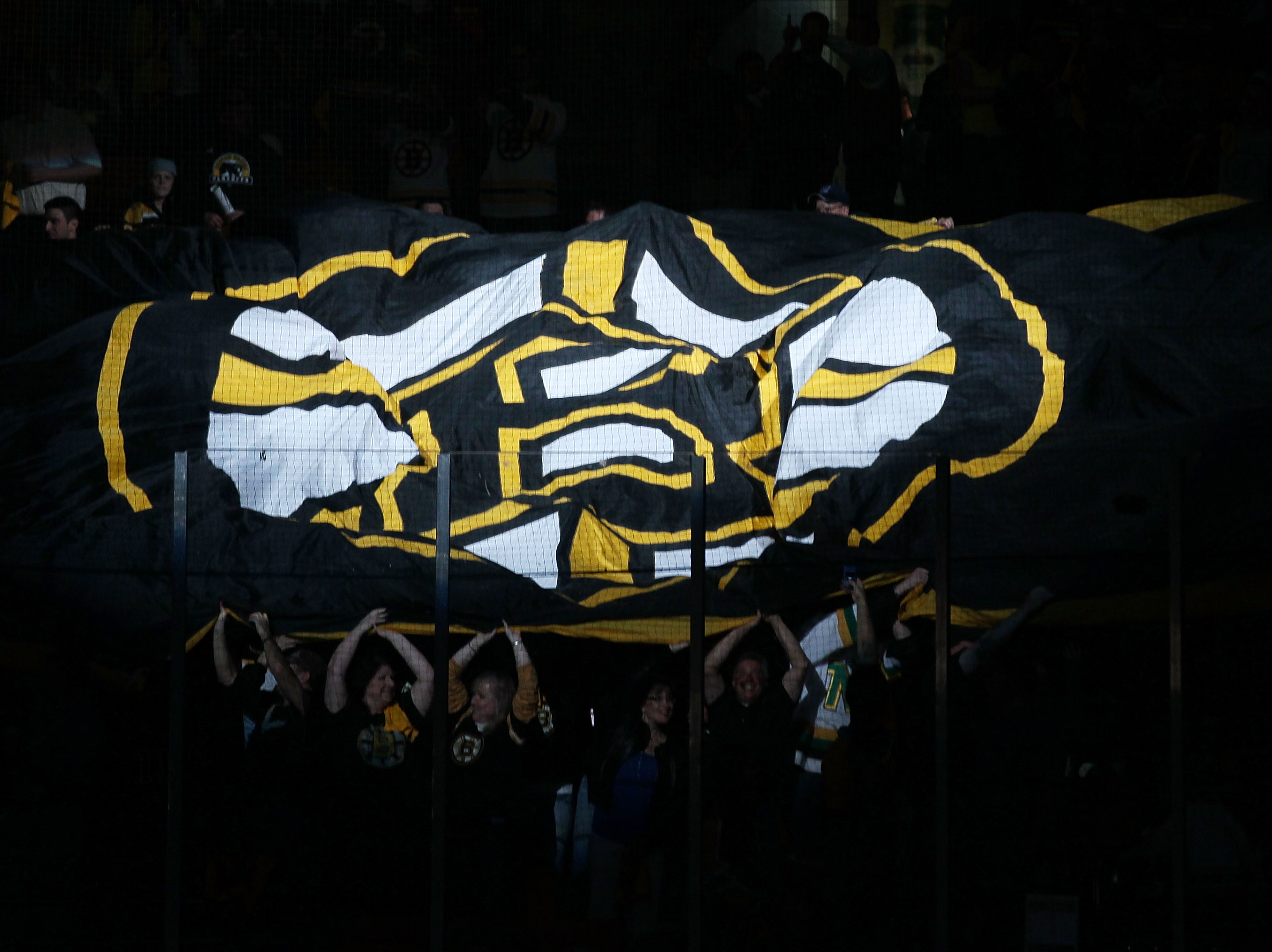 BOSTON - MAY 14:  Fans pass a giant flag before the Boston Bruins take on the Philadelphia Flyers in Game Seven of the Eastern Conference Semifinals during the 2010 NHL Stanley Cup Playoffs at TD Garden on May 14, 2010 in Boston, Massachusetts.  (Photo by