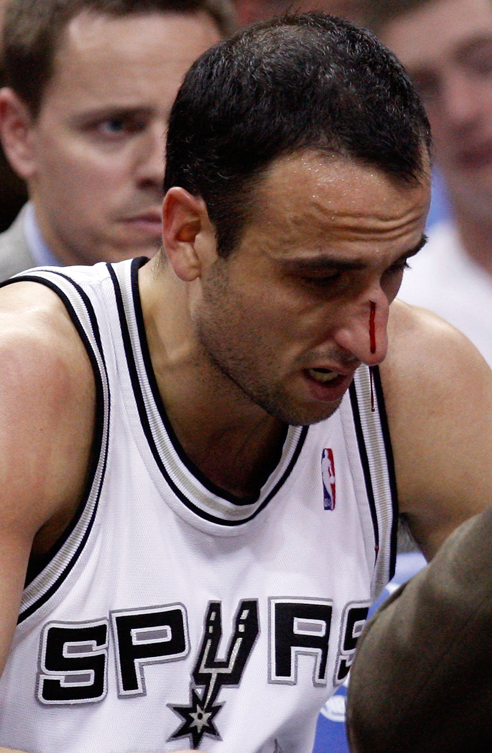 SAN ANTONIO - APRIL 23: Guard Manu Ginobili #20 of the San Antonio Spurs is attended to after being hit in the nose against the Dallas Mavericks in Game Three of the Western Conference Quarterfinals during the 2010 NBA Playoffs at AT&T Center on April 23