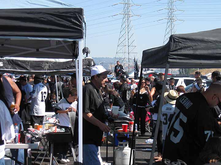 Oakland Raiders fans tailgate in rain at their team's likely last