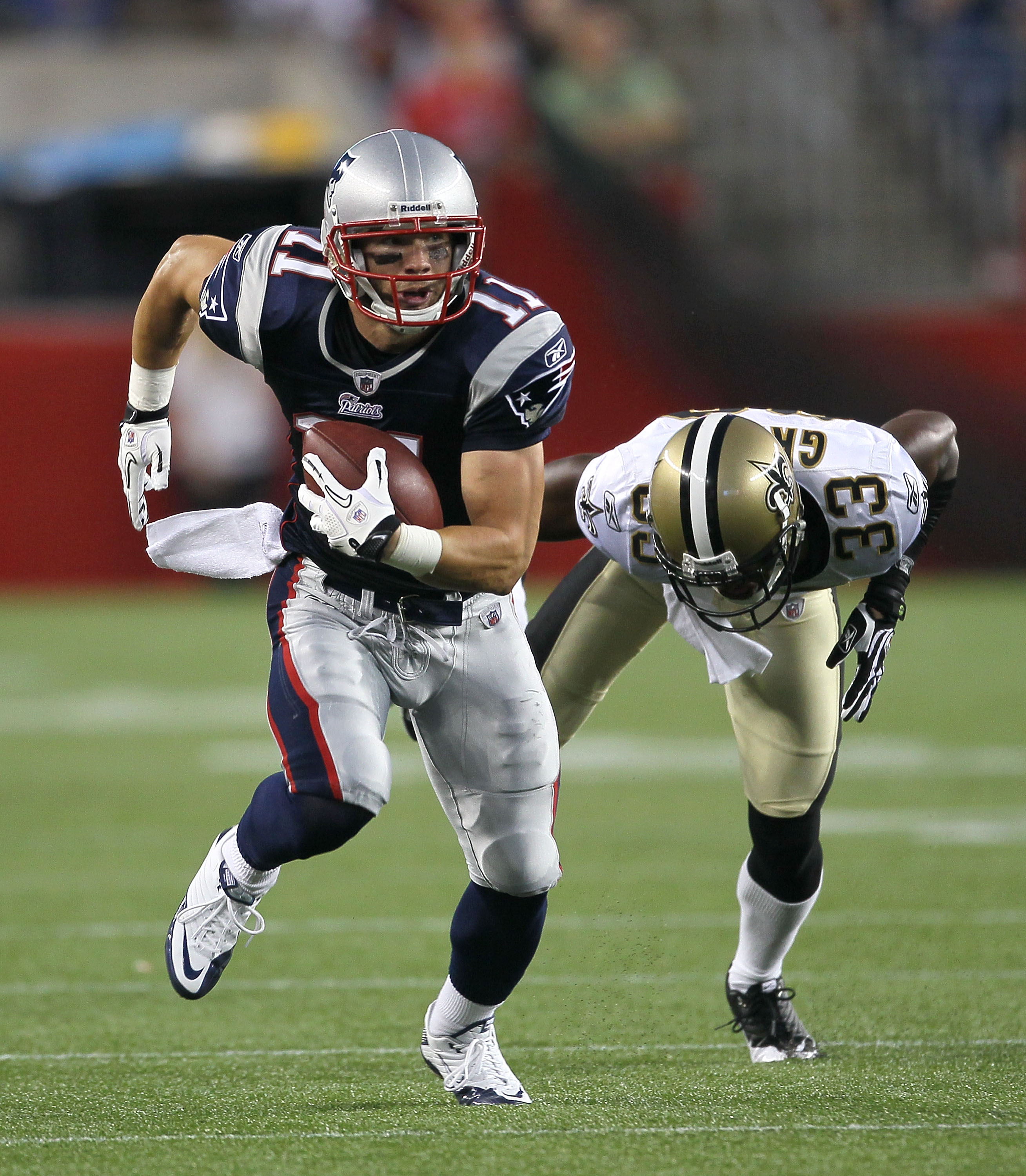 FOXBORO, MA - AUGUST 12: Julian Edelman # 11 of the New England Patriots gains yards against the defense of Jabari Greer # 33 of the New Orlean Saints during the preseason at Gillette Stadium on August 12, 2010 in Foxboro, Massachusetts. (Photo by Jim Rog