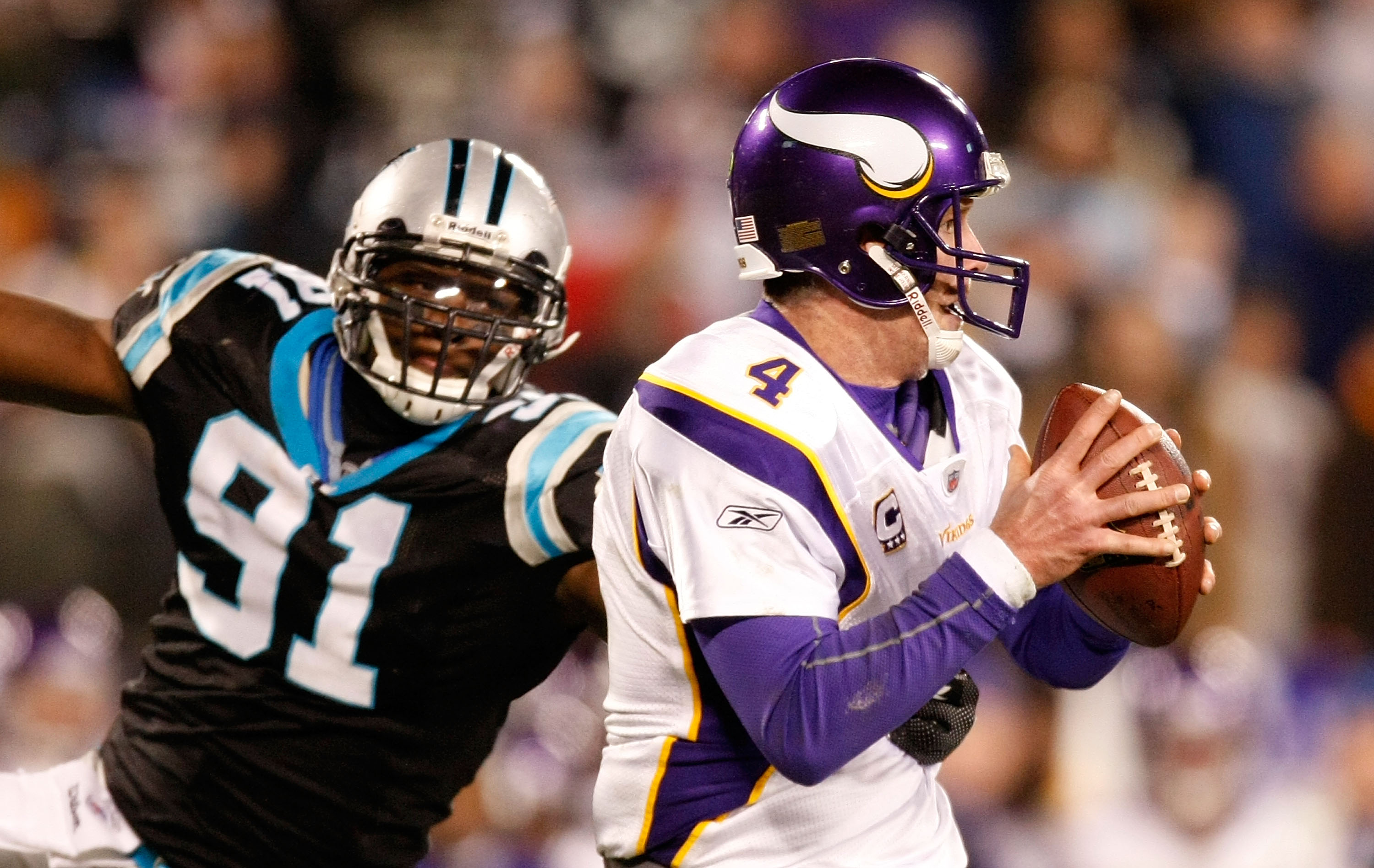 CHARLOTTE, NC - DECEMBER 20: Quarterback Brett Favre #4 of the Minnesota Vikings is pressured by Everette Brown #91 of the Carolina Panthers at Bank of America Stadium on December 20, 2009 in Charlotte, North Carolina. (Photo by Kevin C. Cox/Getty Image