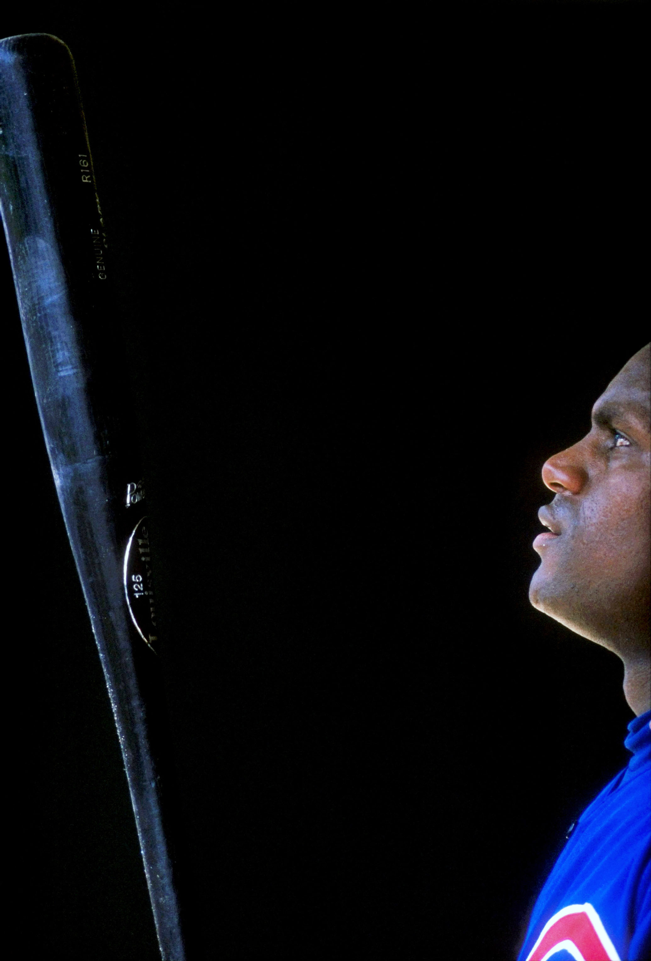 St. LOUIS - AUG 9:  (FILE PHOTO)  Sammy Sosa #21 of the Chicago Cubs looks at his bat in the dugout before an at-bat against the St. Louis Cardinals August 9, 1998 at Busch Stadium in St. Louis, Missouri. Sosa was caught using a corked bat during a game a
