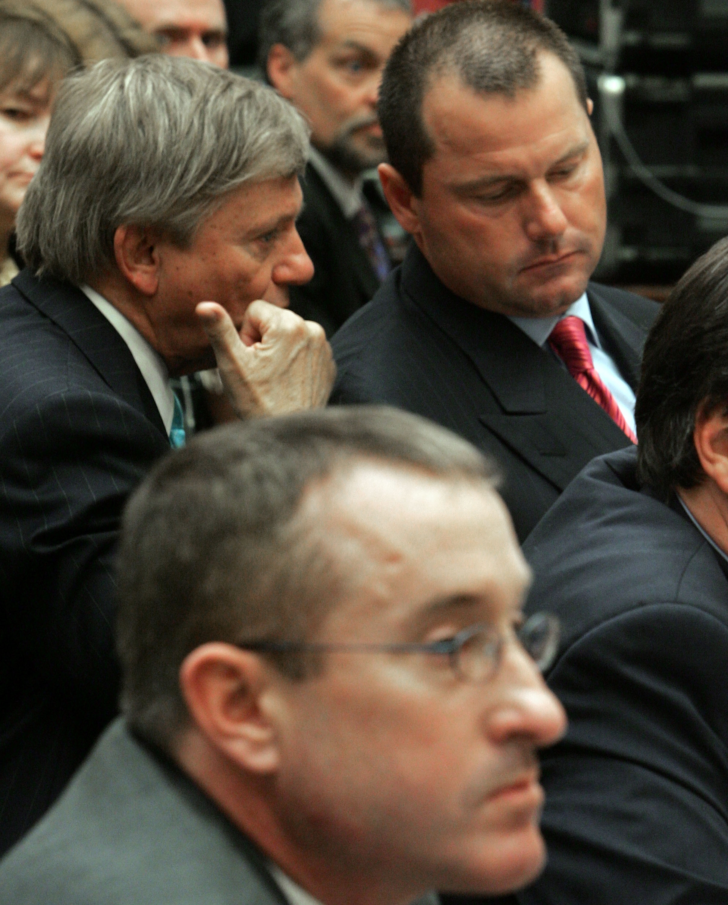 WASHINGTON - FEBRUARY 13:  Major League Baseball player Roger Clemens (R) talks with his attorney Rusty Hardin (L) while Brian McNamee (C), former trainer, sits nearby during a House Oversight and Government Reform Committee hearing February 13, 2008 in W