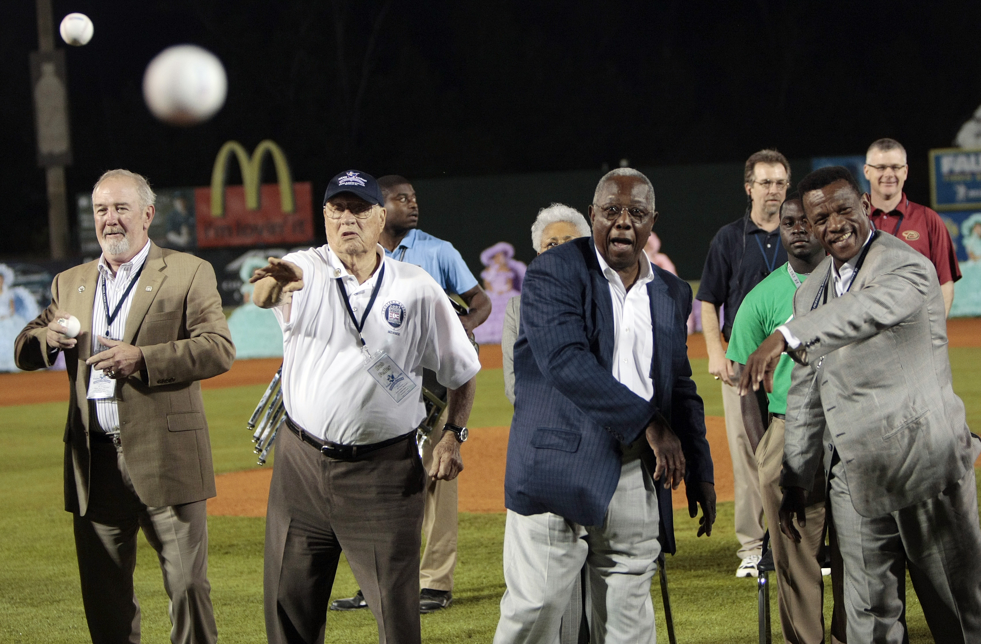 MOBILE, AL - APRIL 14:  Baseball Hall of Famers (L-R) Bruce Sutter, Bob Feller, Hank Aaron and Rickey Henderson throw out the first pitch during pre-game ceremonies following the opening the Hank Aaron Museum at the Hank Aaron Stadium on April 14, 2010 in