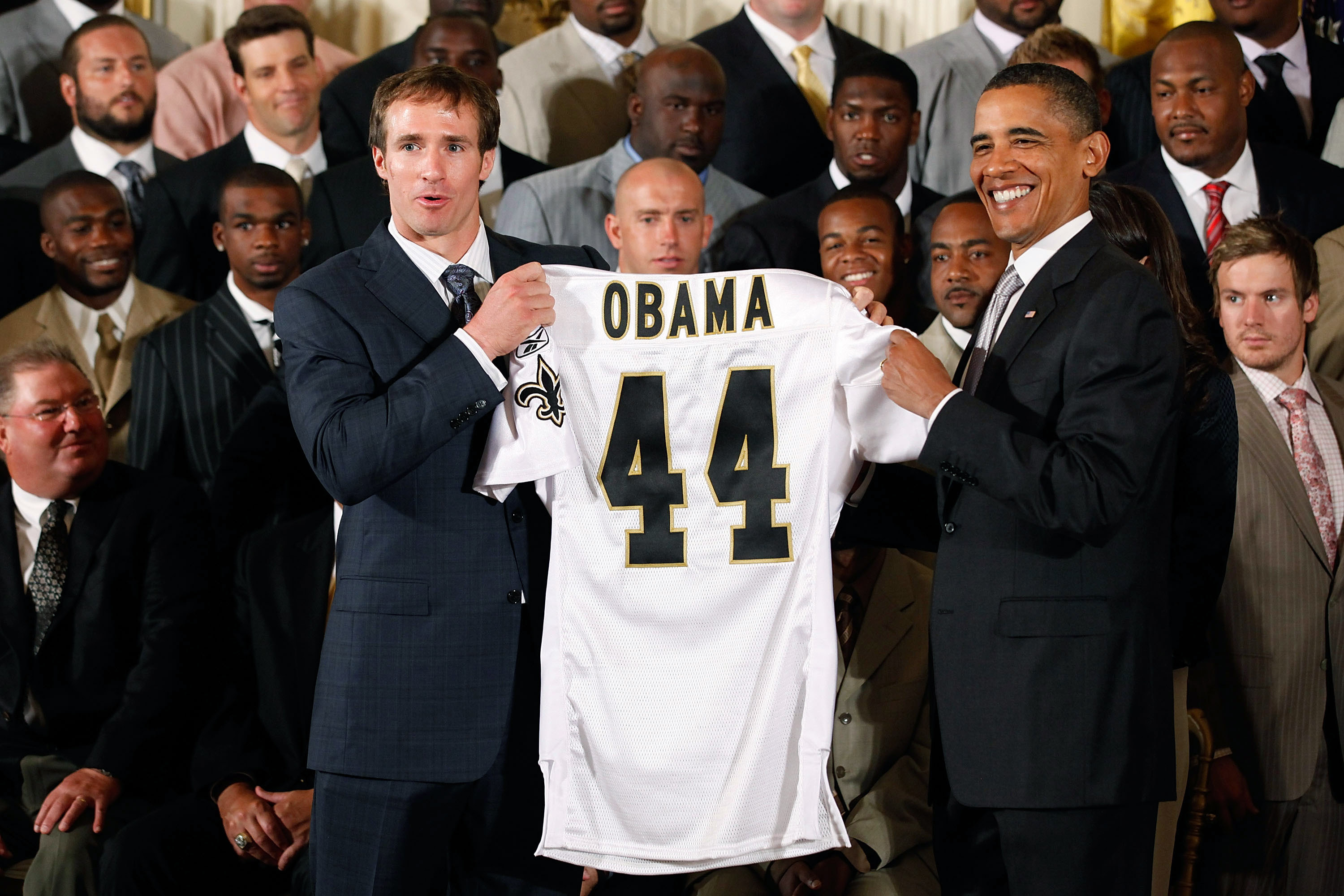 WASHINGTON - AUGUST 09:  New Orleans Saints quarterback and National Football League MVP Drew Brees (L) presents U.S. President Barack Obama (R) with a Saints jersey during a reception for the 2010 National Football League Super Bowl champions at the Whit