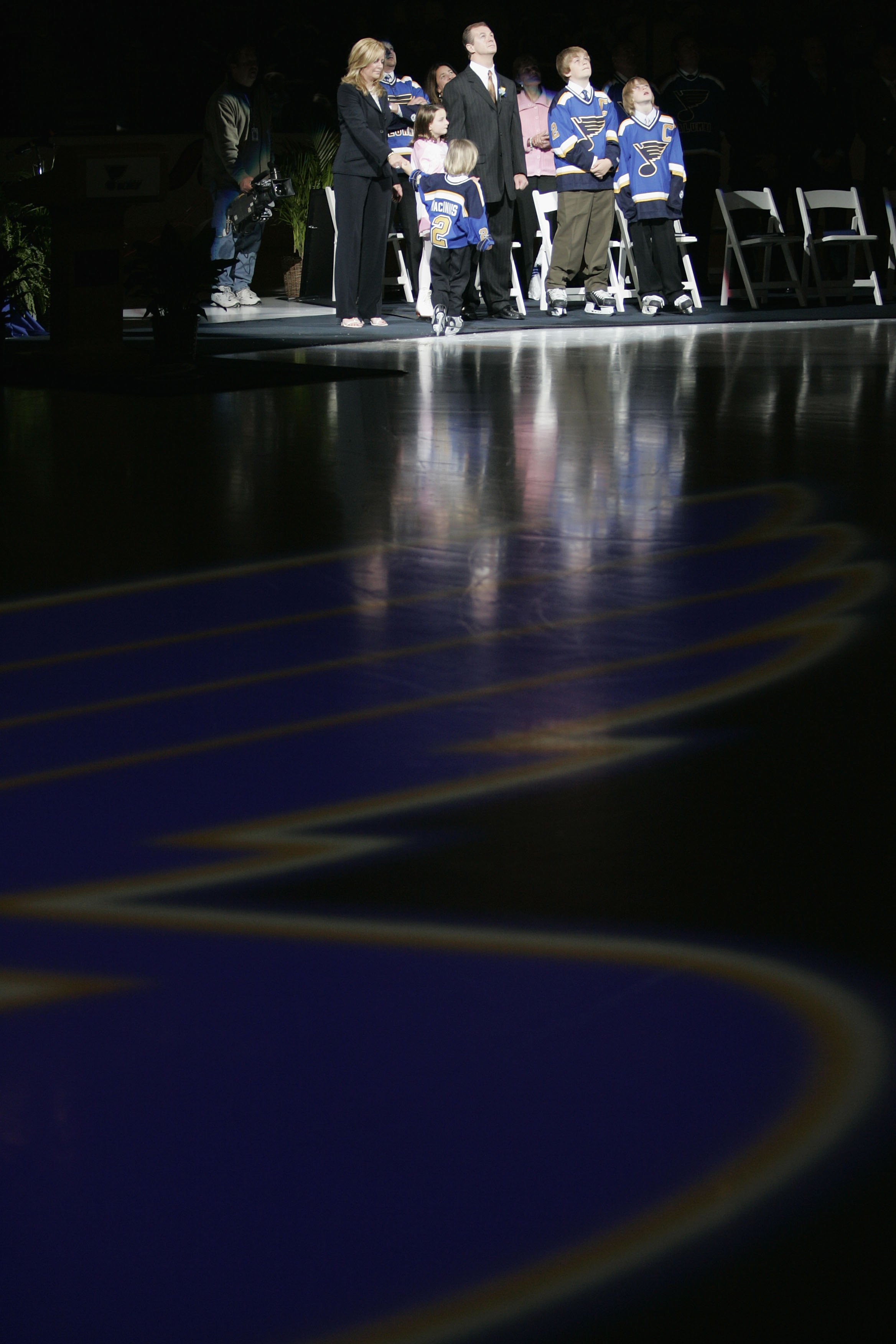 ST. LOUIS - APRIL 9: Former St. Louis Blues defenseman Al MacInnis #2 and his family watch his banner being raised during his jersey retirement ceremony prior to the game between the Blues and Edmonton Oilers at the Savvis Center on April 9, 2006 in St.