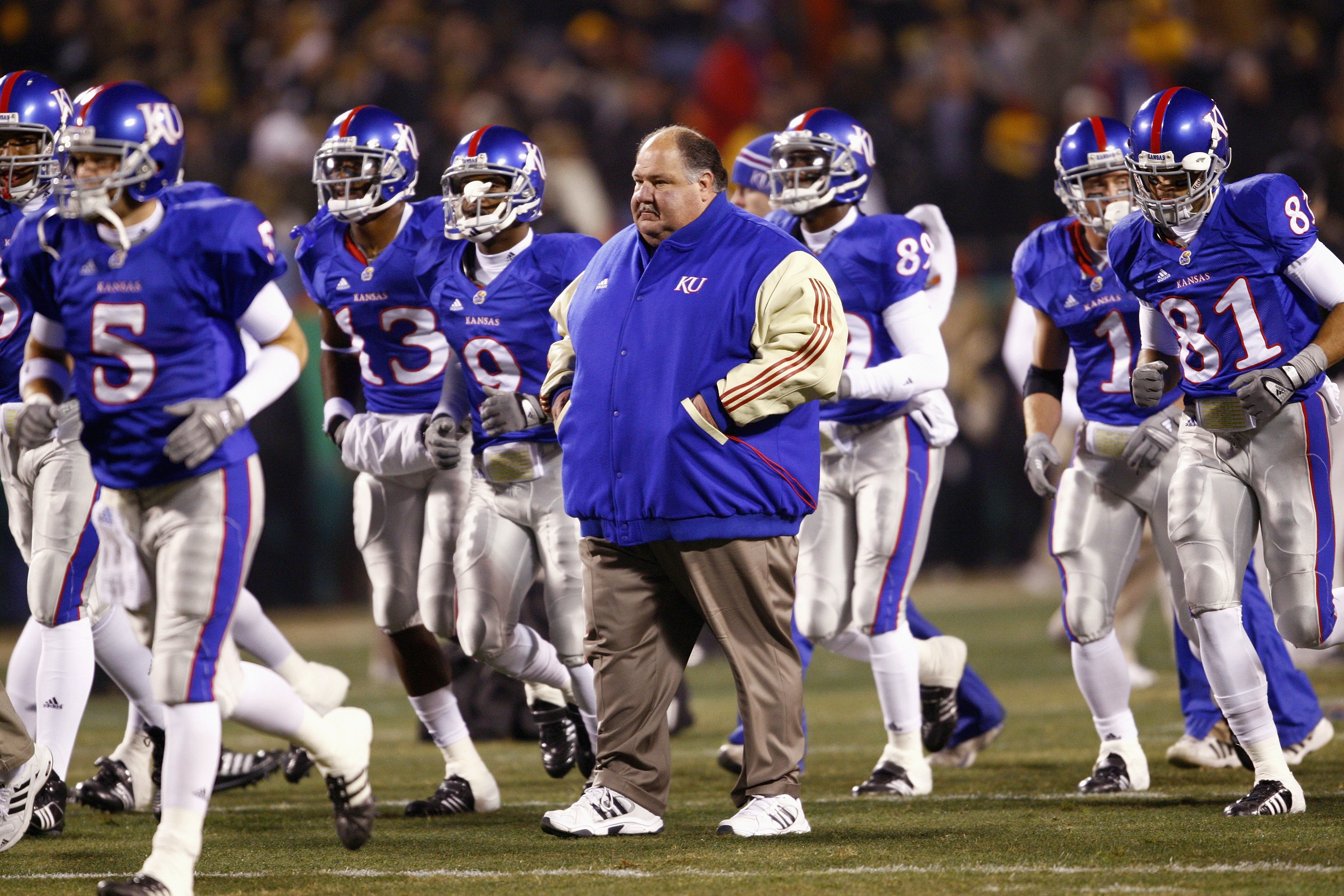 KANSAS CITY, MO - NOVEMBER 24: Coach Mark Mangino of the Kansas Jayhawks walks on the field with his team before the game against the Missouri Tigers at Arrowhead Stadium on November 24, 2007 in Kansas City, Missouri. (Photo by Jamie Squire/Getty Images)