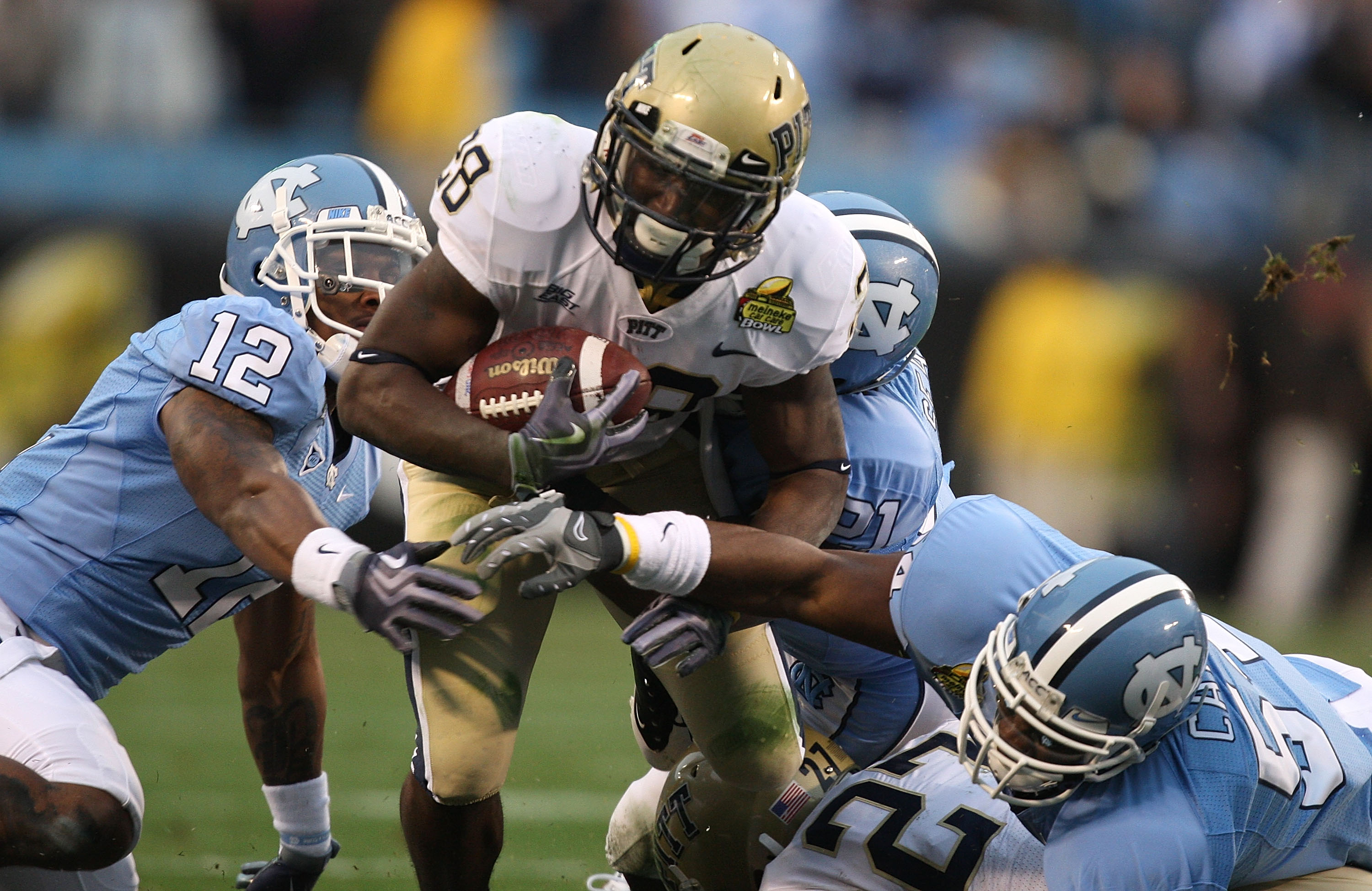 CHARLOTTE, NC - DECEMBER 26: Dion Lewis #28 of the Pittsburgh Panthers runs with the ball against Charles Brown #12 of the North Carolina Tar Heels during their game on December 26, 2009 in Charlotte, North Carolina. (Photo by Streeter Lecka/Getty Image
