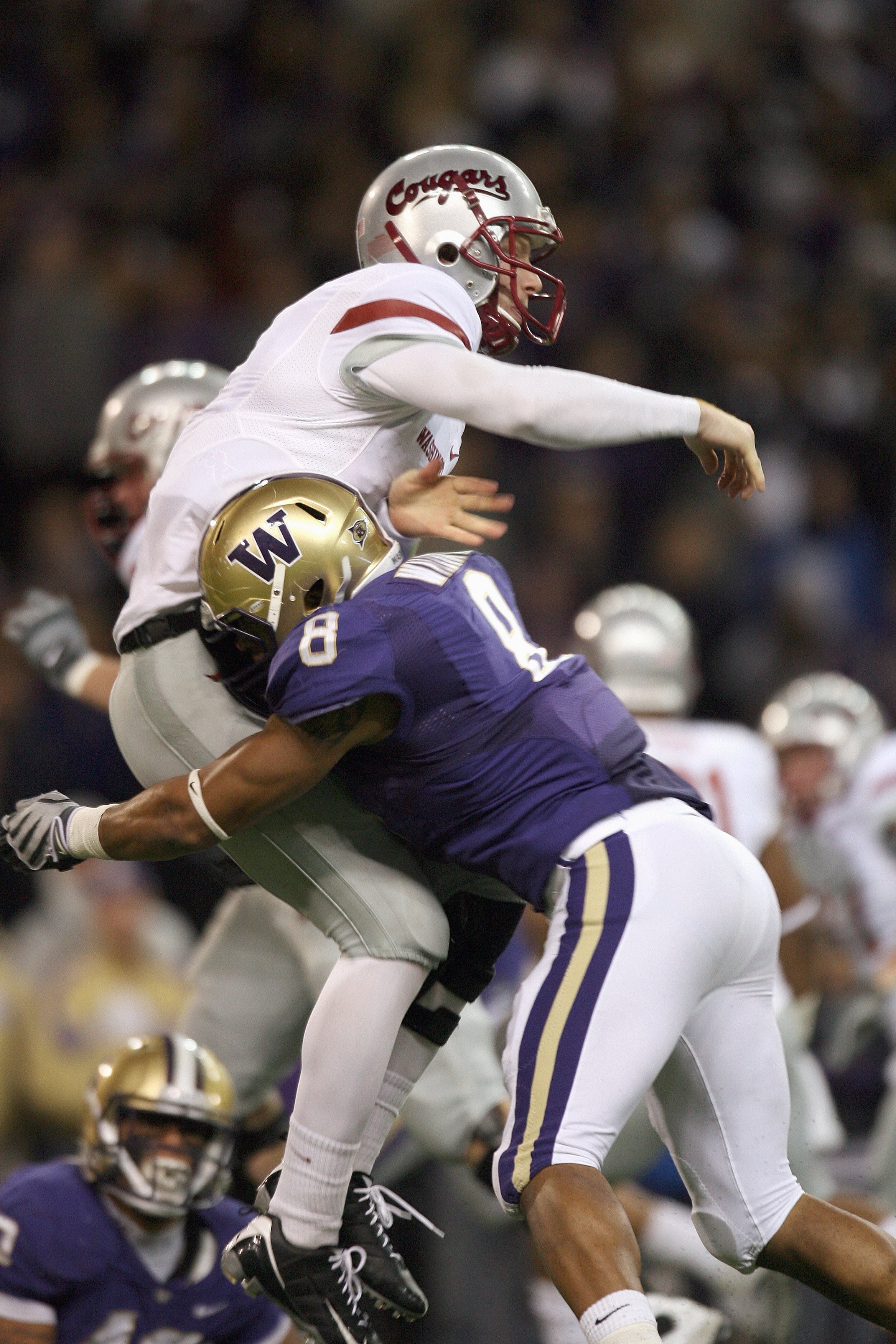 SEATTLE - NOVEMBER 28: Quarterback Marshall Lobbestael #8 of the Washington State Cougars is sacked by Nate Williams #8 of the Washington Huskies on November 28, 2009 at Husky Stadium in Seattle, Washington. The Huskies defeated the Cougars 30-0. (Photo b