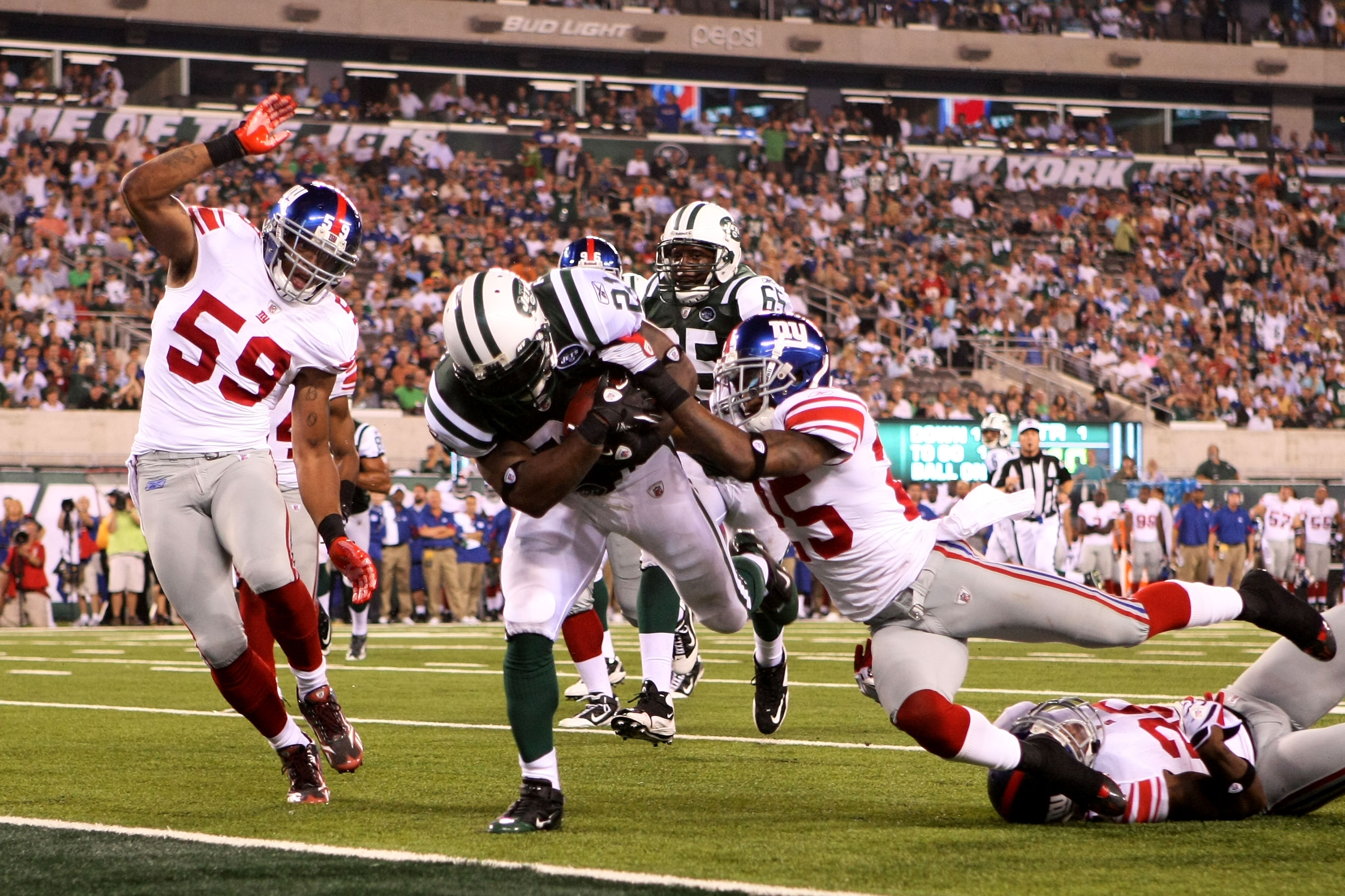 EAST RUTHERFORD, NJ - AUGUST 16:  LaDanian Tomlinson #21 of the New York Jets falls into the endzone for a touchdown that was eventually called back during their game against the New York Giants at New Meadowlands Stadium on August 16, 2010 in East Ruther
