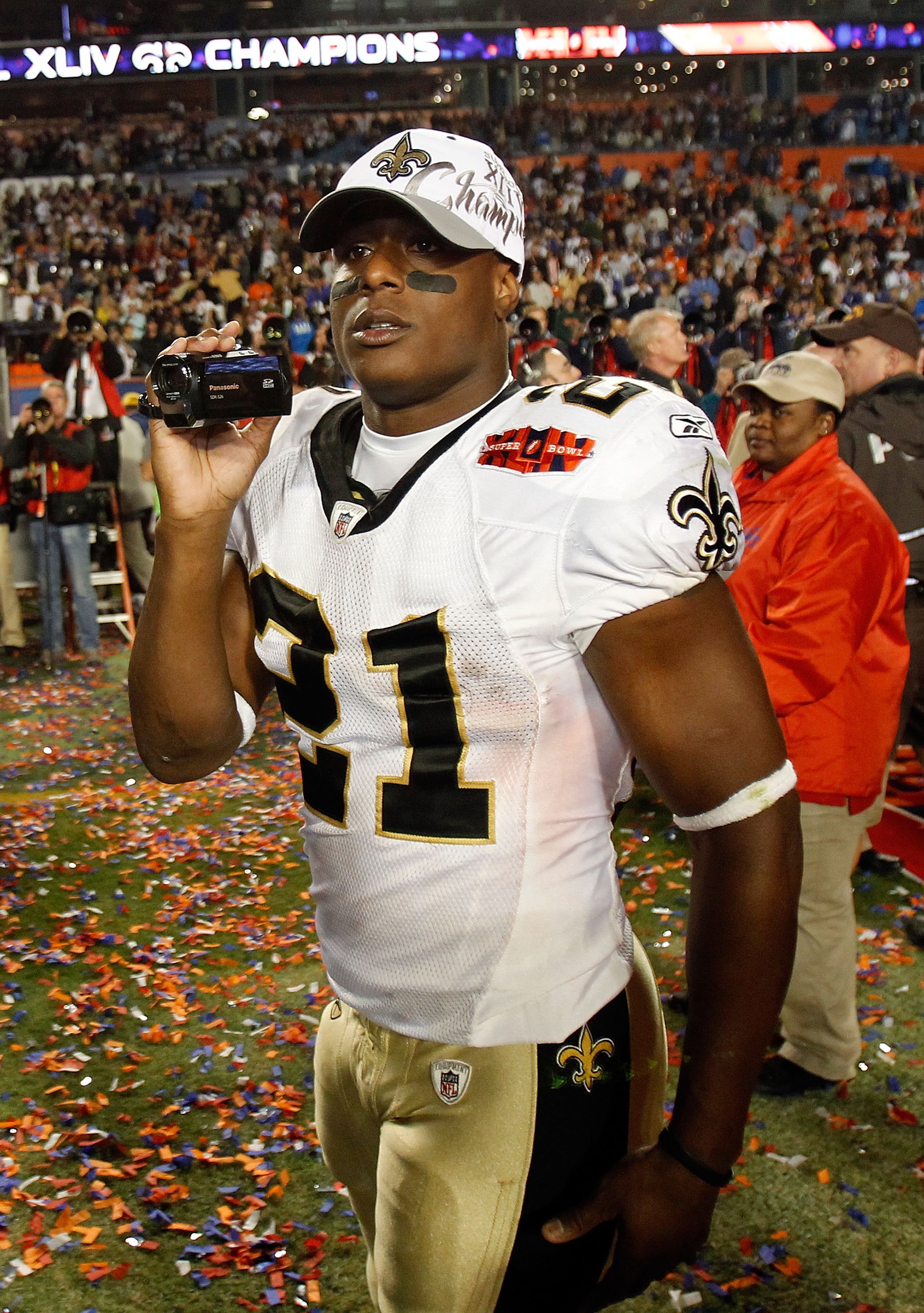 MIAMI GARDENS, FL - FEBRUARY 07:  Mike Bell #21 of the New Orleans Saints video tapes on the field after his team defeated the Indianapolis Colts during Super Bowl XLIV on February 7, 2010 at Sun Life Stadium in Miami Gardens, Florida.  (Photo by Jonathan