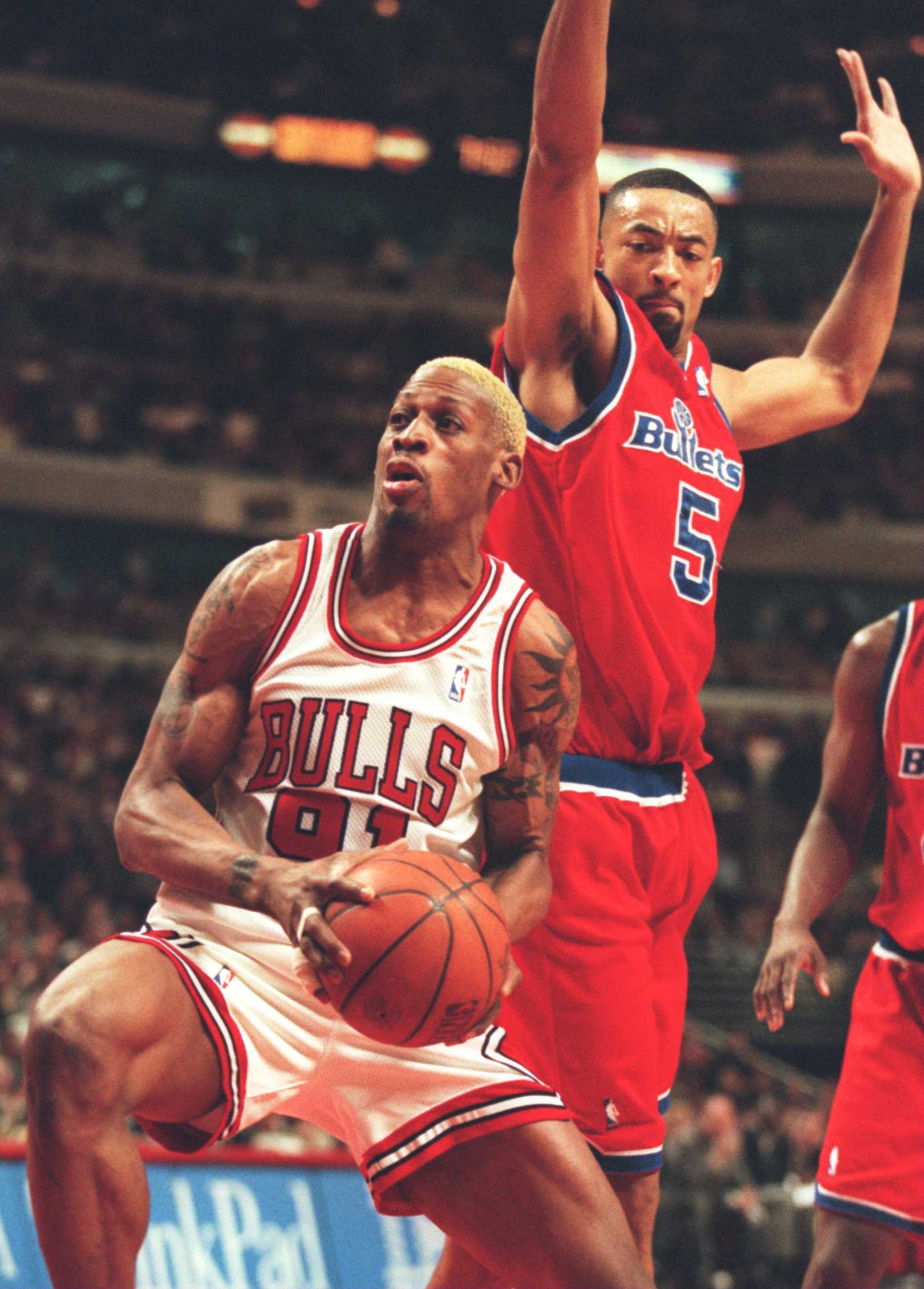 13 Mar 1996:  Foward DennisRodman #91 of the Chicago Bulls attempts to manuever for an open shot while forward  Juwan Howard of the Washington Bullets attempts to block shot during the Bulls game against the Bullets at the United Center in Chicago, Illino