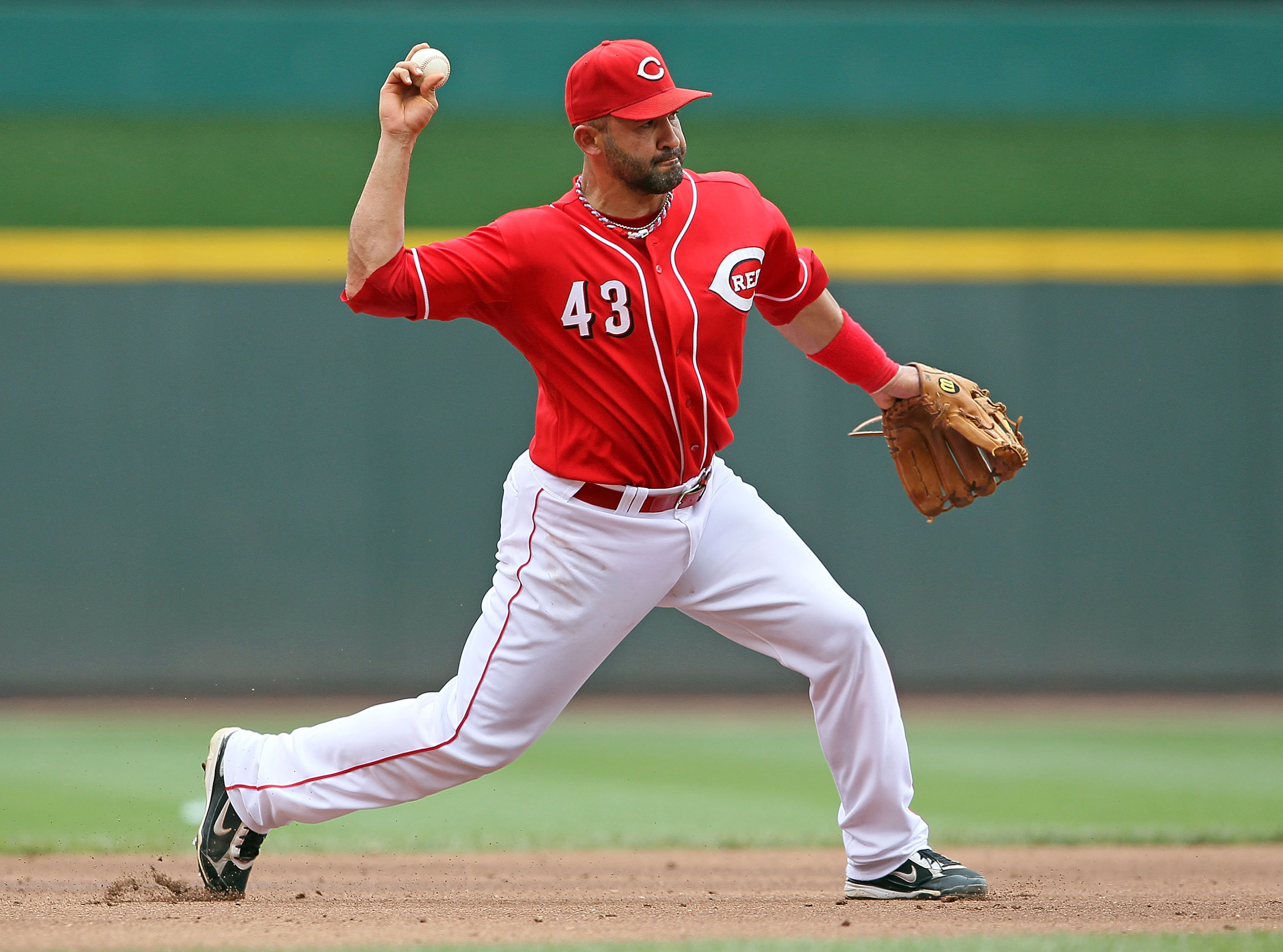 CINCINNATI - JULY 18: Miguel Cairo #43 of the Cincinnati Reds throws the ball to first base during the game against the Colorado Rockies at Great American Ball Park on July 18, 2010 in Cincinnati, Ohio.  (Photo by Andy Lyons/Getty Images)