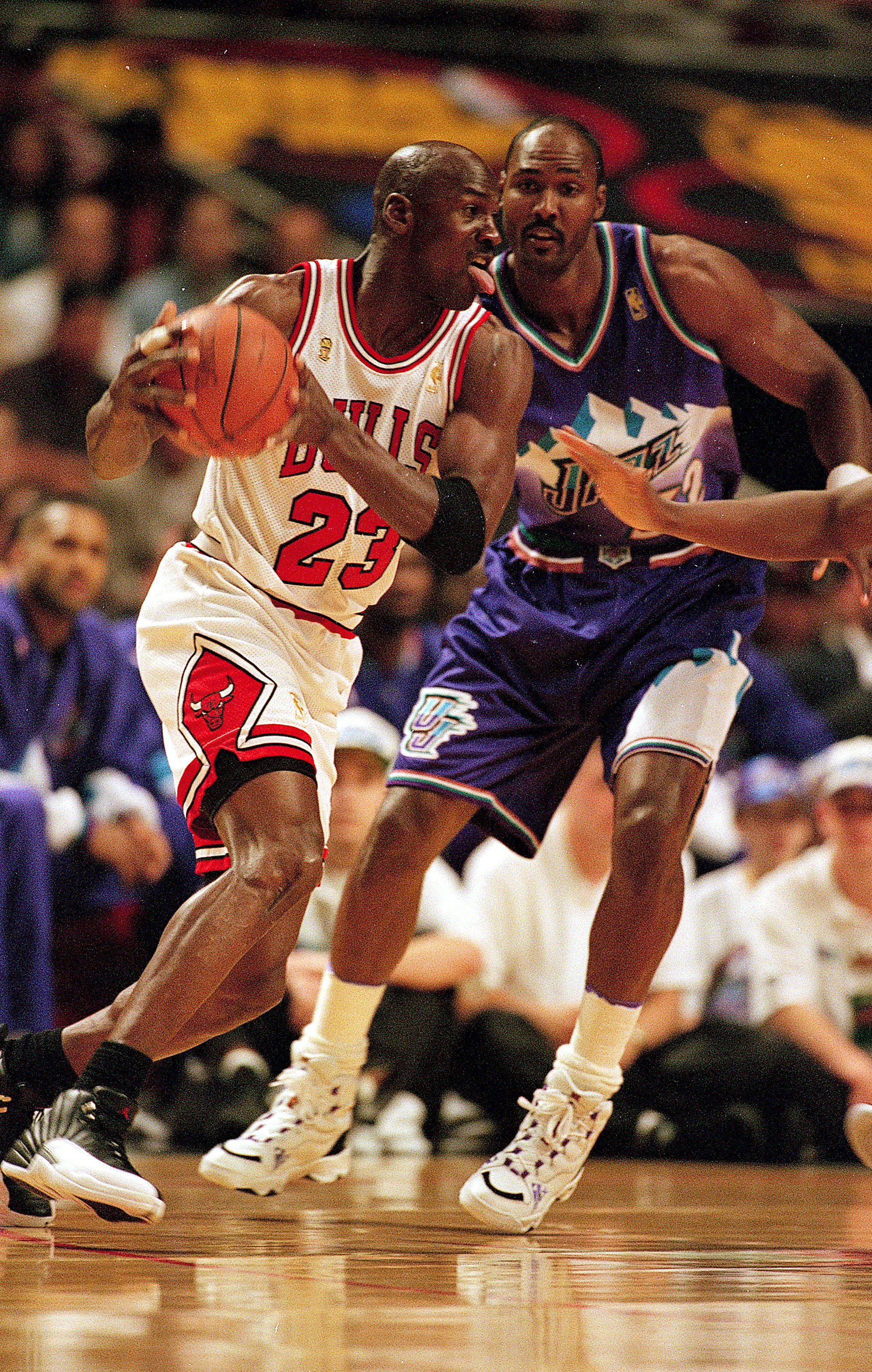 I3 Jun 1997:  Michael Jordan #23 of the Chicago Bulls dribbles the ball as he is guarded by Karl Malone #32 of the Utah Jazz during game six of the NBA Final at the United Center in Chicago, Illinois. The Bulls defeated the Jazz 90-86..   Mandatory Credit