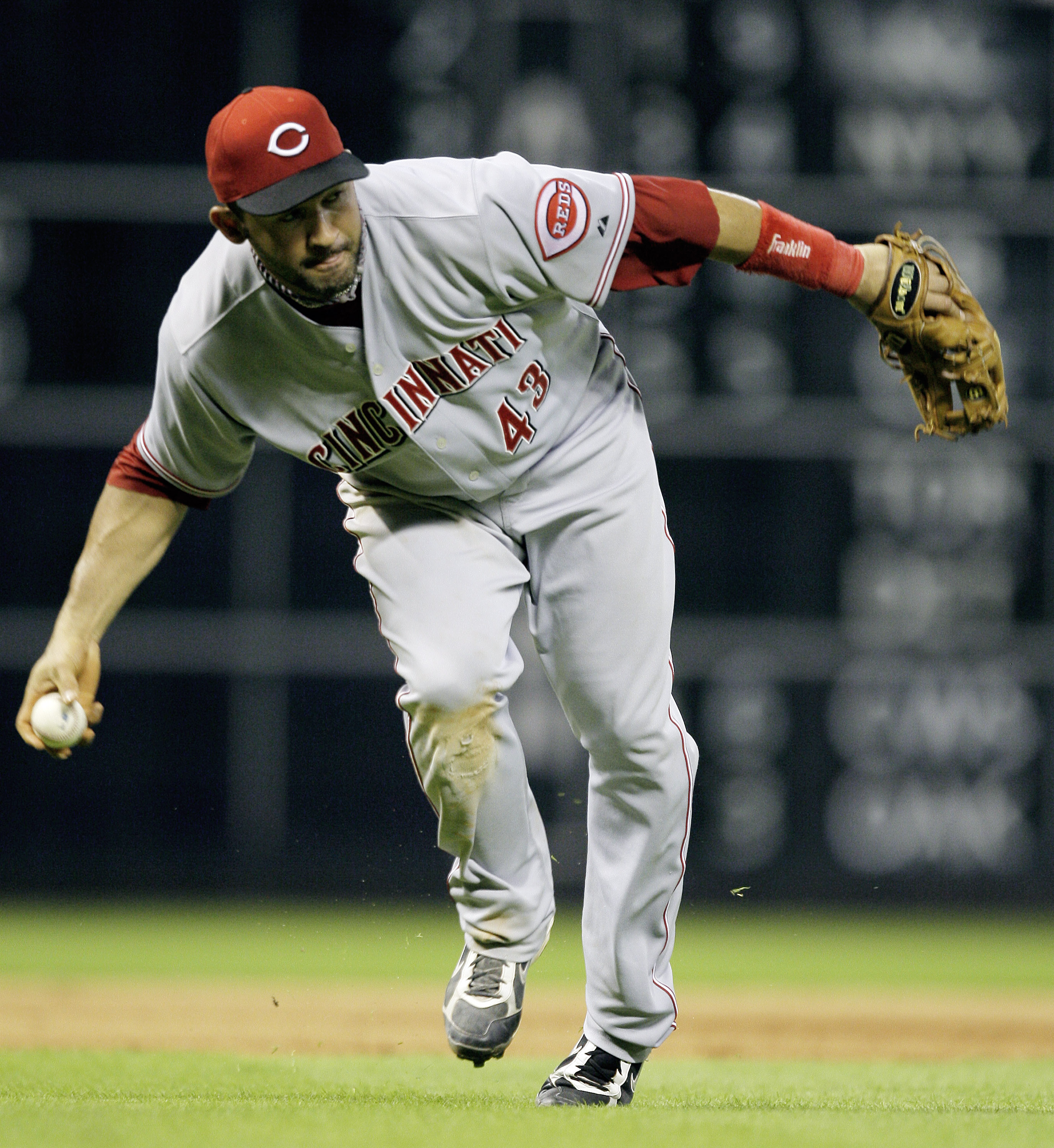 HOUSTON - JULY 23:  Third baseman Miguel Cairo #43 of the Cincinnati Reds makes a play on a slow roller against the Houston Astros at Minute Maid Park on July 23, 2010 in Houston, Texas.  (Photo by Bob Levey/Getty Images)