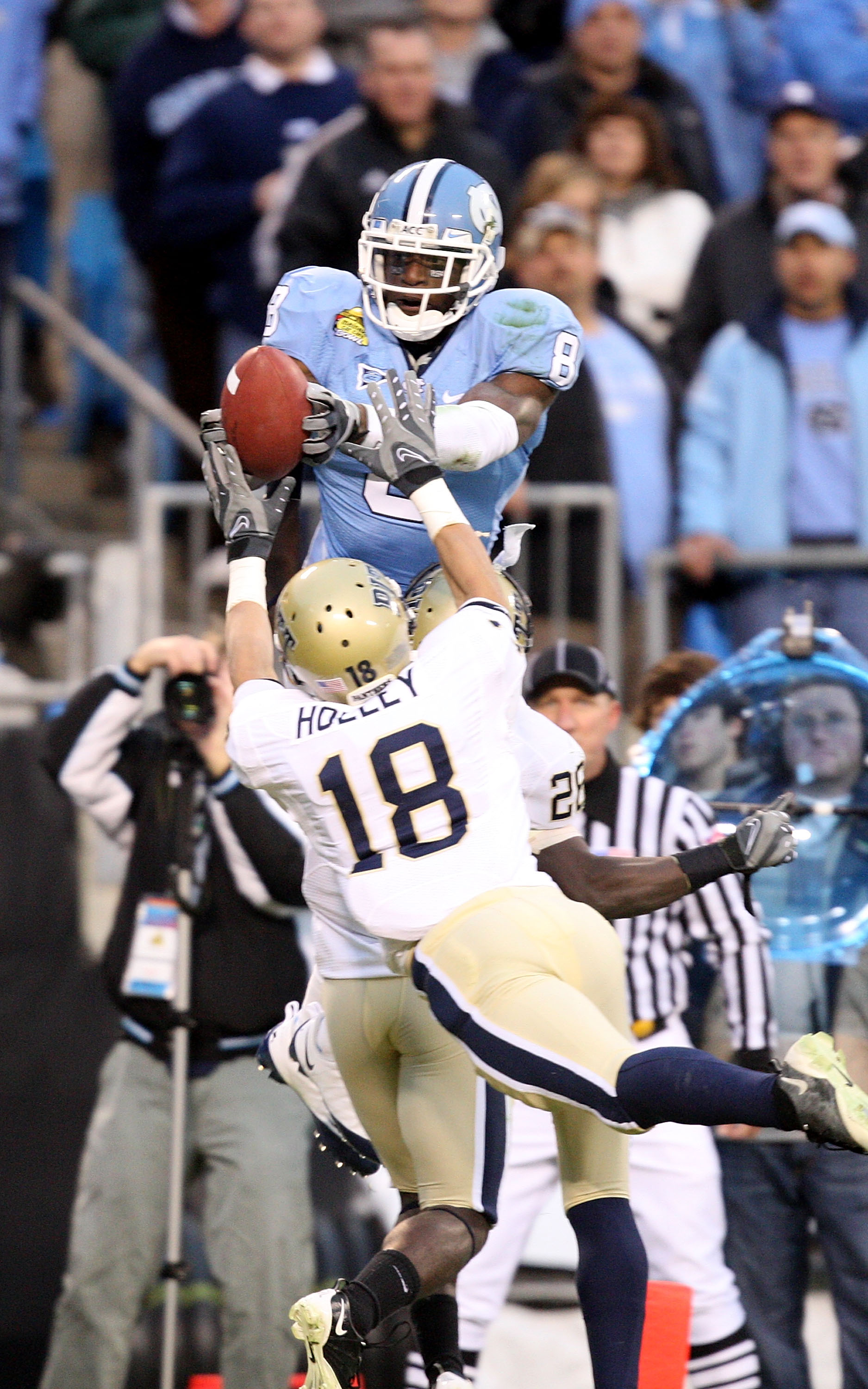 CHARLOTTE, NC - DECEMBER 26:  Jarred Holley #18 of the Pittsburgh Panthers watches as Greg Little #8 of the North Carolina Tar Heels catches a touchdown during their game on December 26, 2009 in Charlotte, North Carolina.  (Photo by Streeter Lecka/Getty I