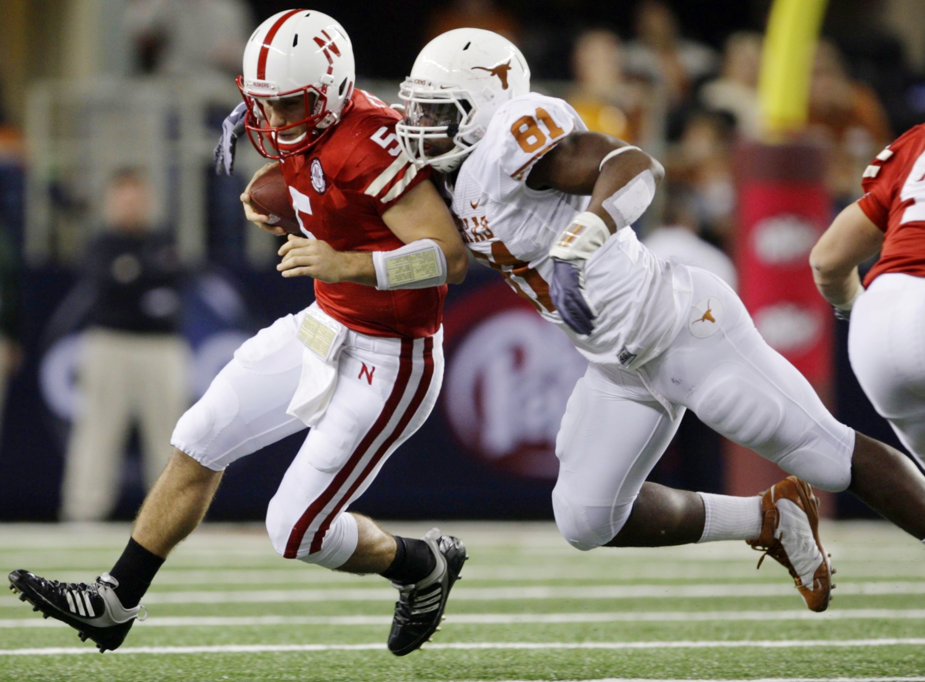 ARLINGTON, TX - DECEMBER 5: Quarterback Zac Lee of the Nebraska Cornhuskers is sacked by Sam Acho #81 of the Texas Longhorns at Cowboys Stadium on December 5, 2009 in Arlington, Texas. (Photo by Jamie Squire/Getty Images)