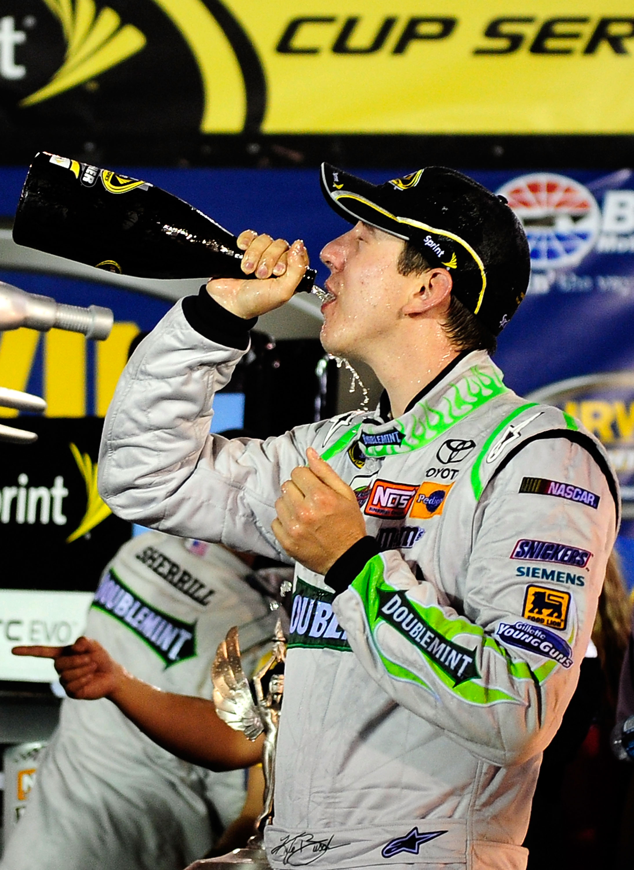 BRISTOL, TN - AUGUST 21: Kyle Busch, driver of the #18 Doublemint Toyota, drinks champagne in Victory Lane after winning the NASCAR Sprint Cup Series IRWIN Tools Night Race at Bristol Motor Speedway on August 21, 2010 in Bristol, Tennessee. (Photo by Ru