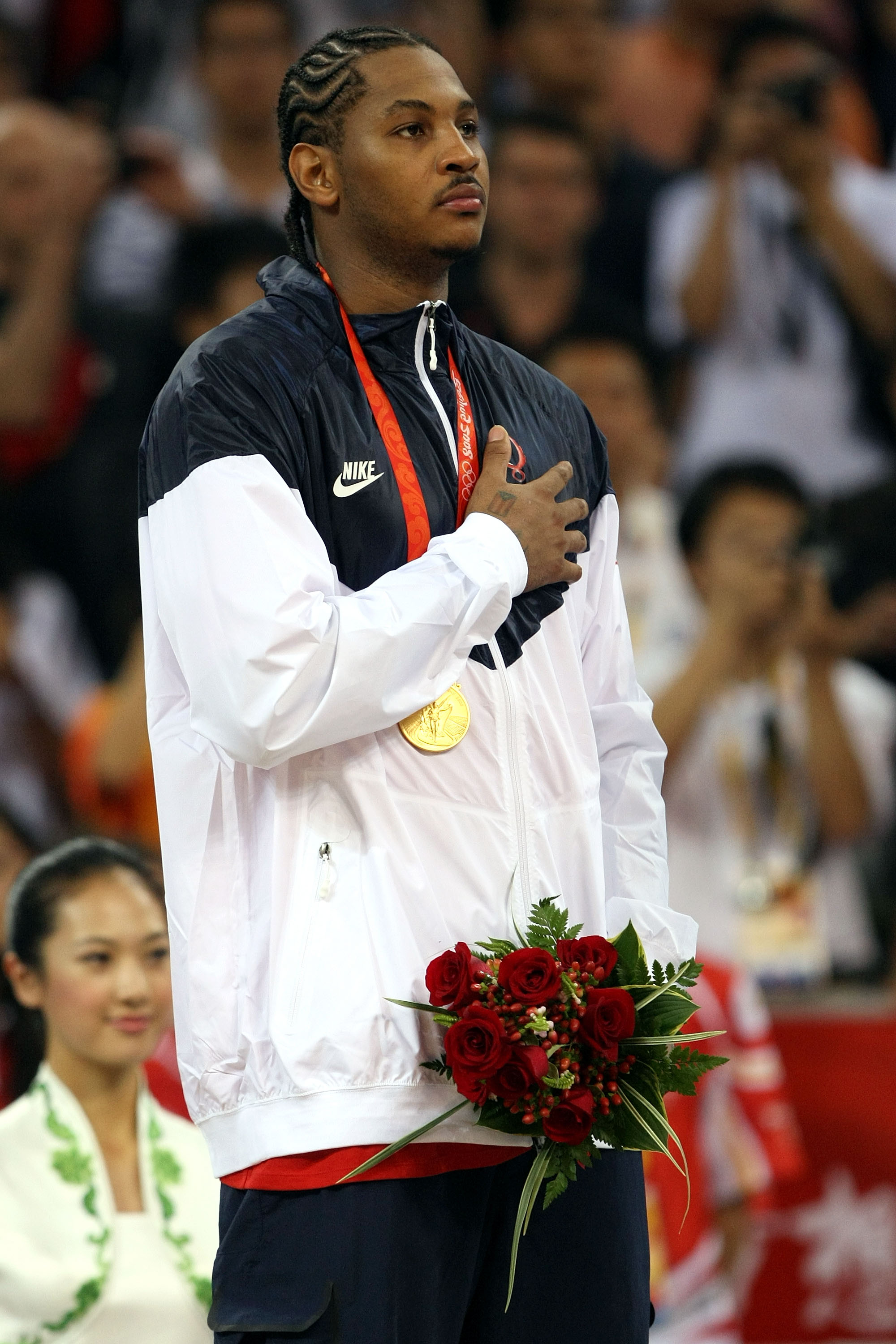 BEIJING - AUGUST 24:  Carmelo Anthony #15 of the United States salutes as his countries National Anthem is played during the medal ceremony after defeating Spain 118-107 in the gold medal game during Day 16 of the Beijing 2008 Olympic Games at the Beijing