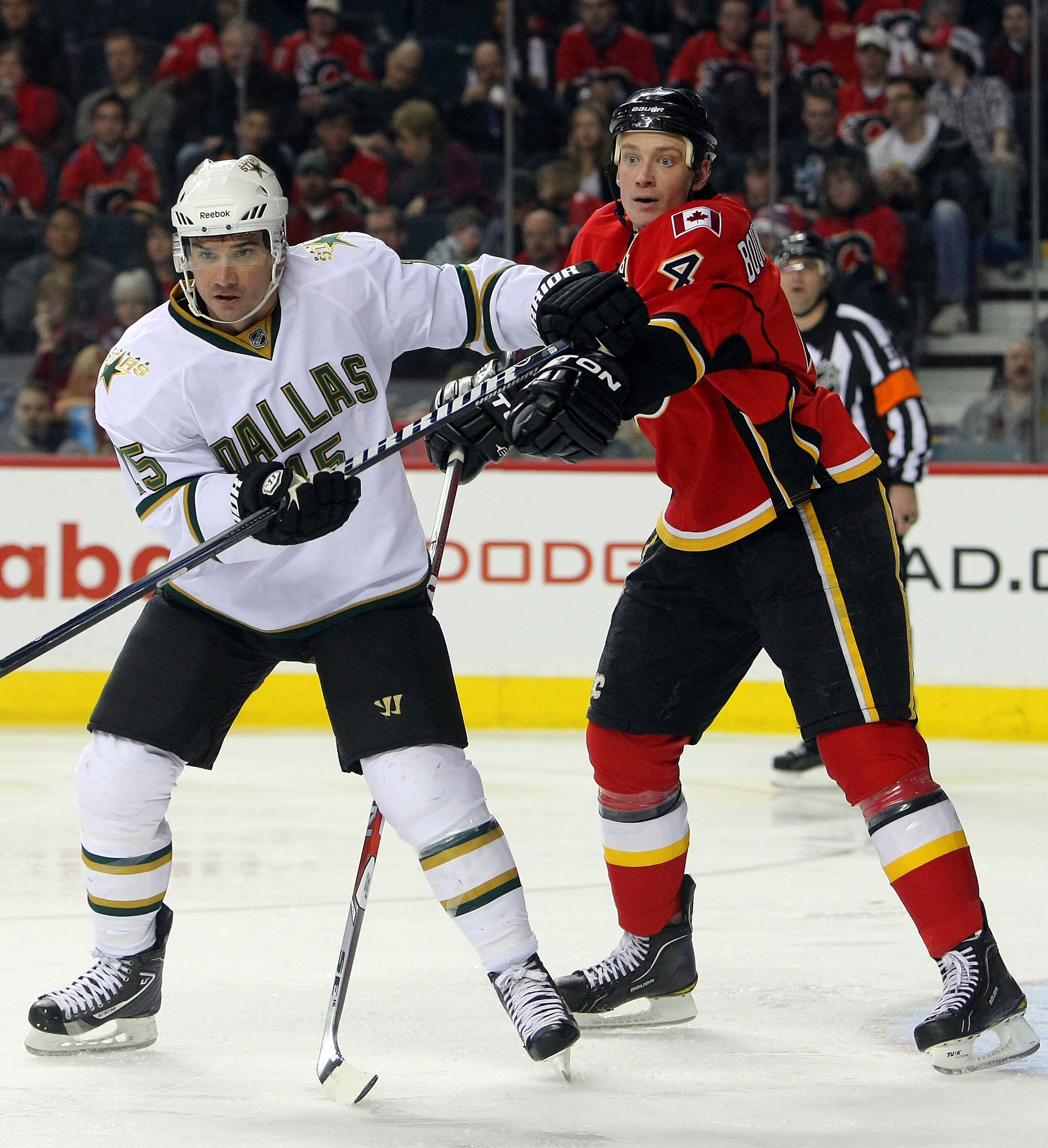 CALGARY, CANADA - FEBRUARY 16:  Jamie Langenbrunner #15 of the Dallas Stars battles for position with Jay Bouwmeester #4  of the Calgary Flames during their NHL game at Scotiabank Saddledome, February 16, 2011 in Calgary, Alberta, Canada. (Photo By Dave S
