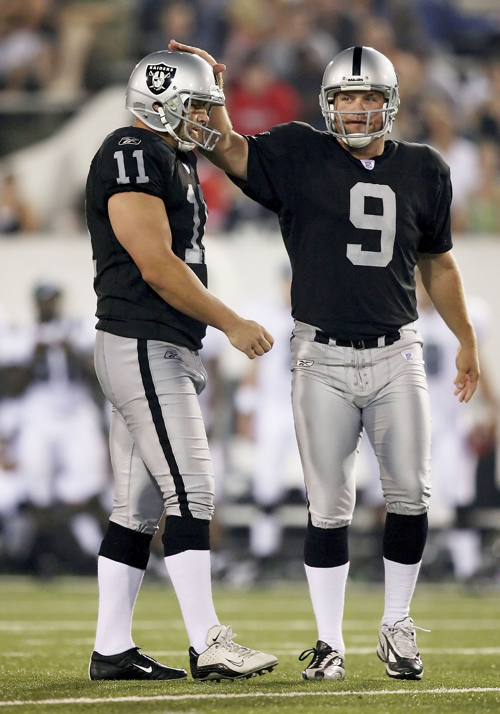 CANTON, OH - AUGUST 6: Place kicker Sebastian Janikowski #11 of the Oakland Raiders is congratulated by holder Shane Lechler #9 after Janikowskit kicked a 51-yard field goal in the third quarter against the Philadelphia Eagles in the AFC-NFC Pro Football 