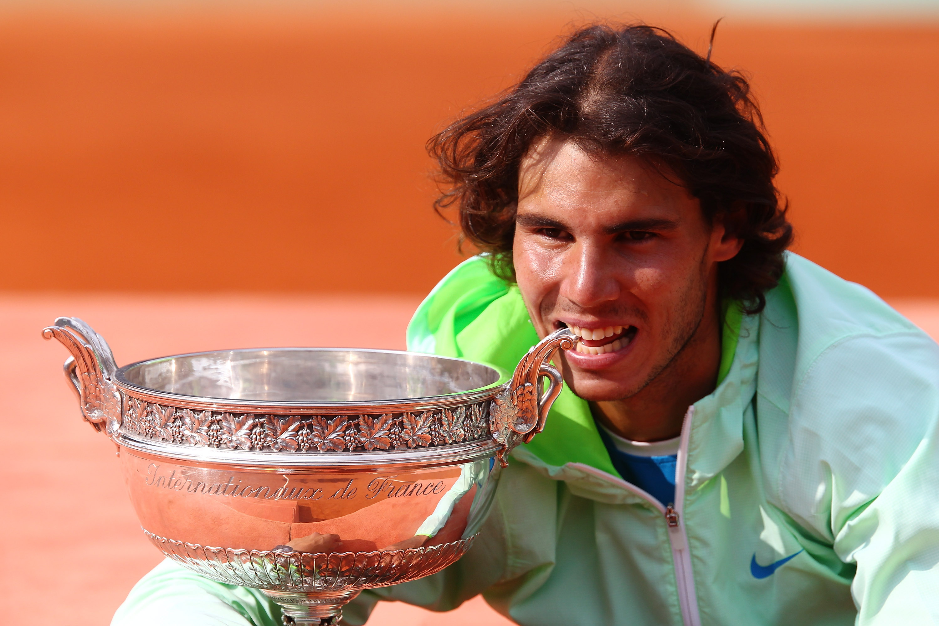 PARIS - JUNE 06:  Rafael Nadal of Spain celebrates with the trophy after winning the men's singles final match between Rafael Nadal of Spain and Robin Soderling of Sweden on day fifteen of the French Open at Roland Garros on June 6, 2010 in Paris, France.